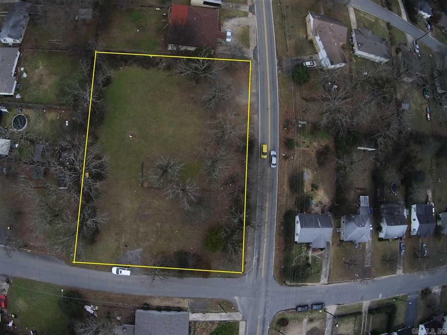 Huge .65 acre corner lot right in town.  Ready for building and priced to move FAST!!  Don't let this opportunity pass by.  Great area amenities and conveniently located to shopping, restaurants, freeway access, and Burns Park.  Property is mostly level with a very slight slope off the backside, cleared with just the right amount of shade trees.  Utilities available but unknown if any are currently on-site.