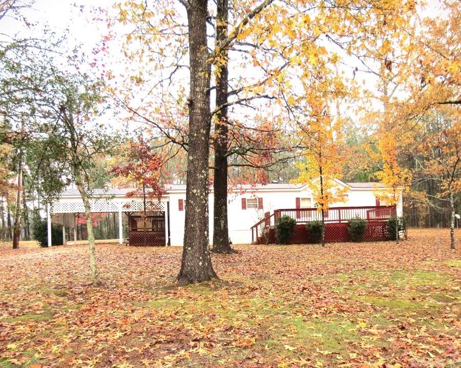 3 bedroom 2 bath doublewide mobile home sits back off Hwy 35 on 2.79 acres.  This home has a split floor plan, large living area and kitchen, dining area.  Laundry room is good size.  Front deck or backyard is best place to watch the wildlife.  Carport on side of home for easy access.  Cleveland County School District.  Outdoor storage.  Mature trees. Call today for your personal tour.