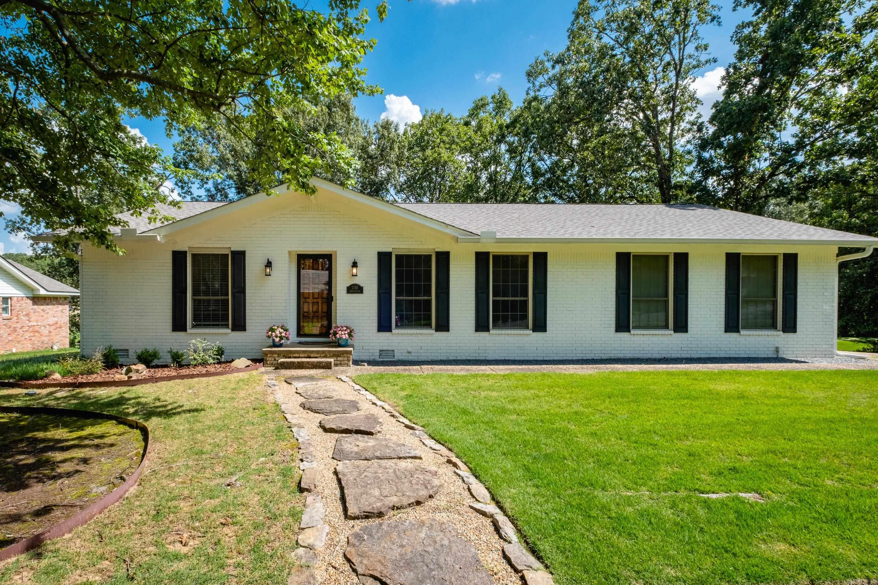 Nestled on a spacious corner lot in North Little Rock's desirable Overbrook subdivision, this one-level, 3-bedroom, 2-bath home offers comfortable and convenient living. Step inside to discover new paint and flooring throughout, creating a fresh and inviting atmosphere. The home boasts spacious living and dining areas, providing ample space for relaxing and entertaining. For those who work from home or enjoy creative pursuits, a dedicated home office/studio offers a quiet retreat. You'll also appreciate the oversized utility room complete with a full-size sink and storage space. The two-car garage isn't just for parking; it's an entertainment hub, featuring a large TV perfect for fall football games or movie nights. Outside, a generous deck overlooks the backyard, offering an ideal spot for outdoor dining or simply enjoying the peaceful surroundings. A convenient trail from the backyard provides direct access to the highly-rated Crestwood Elementary School. Overbook Park pool, tennis and pickleball courts, and playground are only 3 blocks away with the Five Mile Creek trails also nearby.