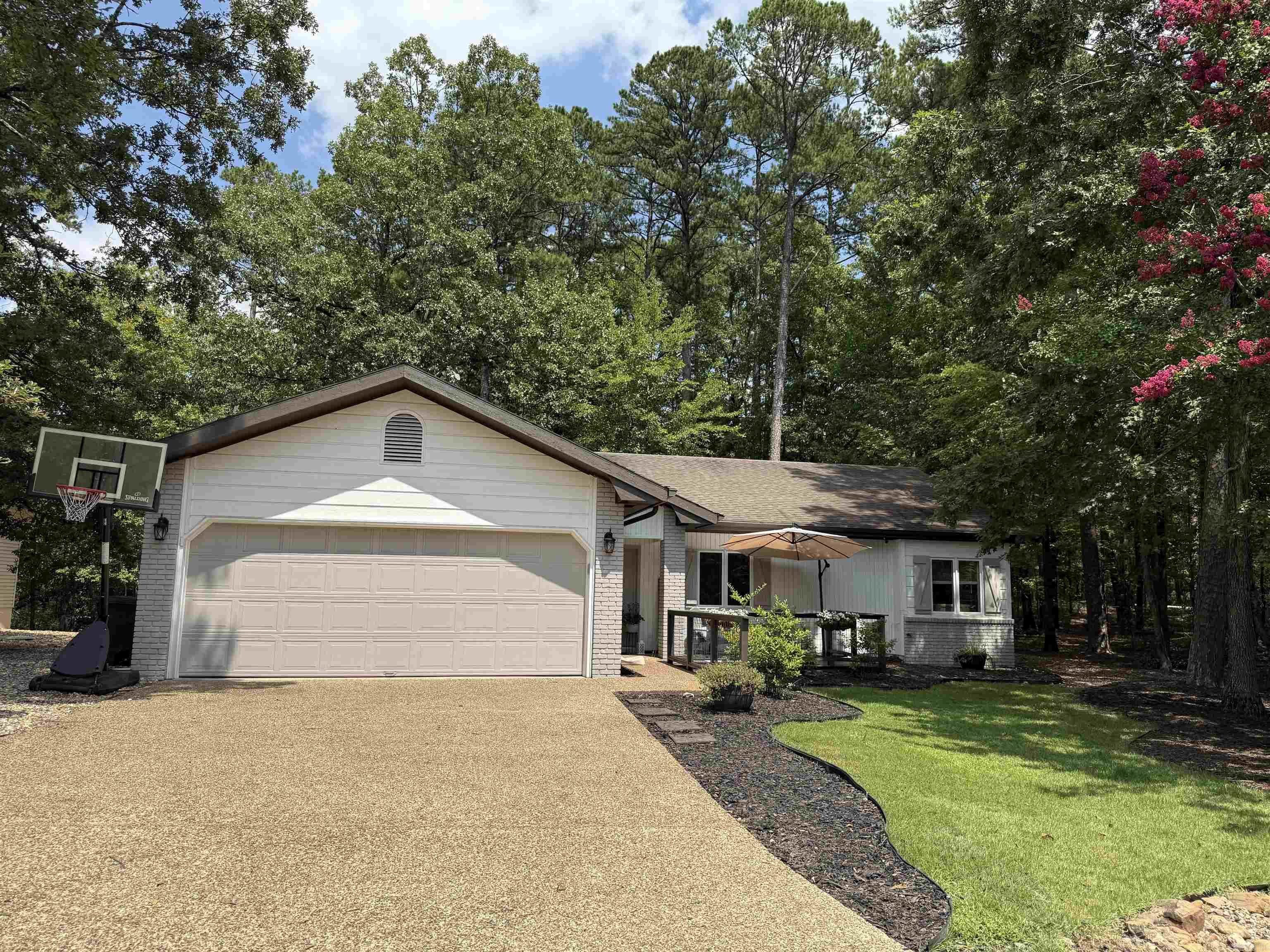 This beautifully remodeled and updated home is the total package - stylish, cozy, and full of charm! The bright, open kitchen features granite countertops, stainless appliances, and a huge bar with seating for 5! The cozy living room with a ventless gas fireplace is perfect for relaxing nights. The primary suite offers an updated walk-in shower and custom shelving in the walk-in closet. There is a small storage building attached perfect for storing hobby supplies, yard tools, or even your holiday decor! Whether you are looking to downsize, in search of a great investment property, or wanting to enjoy the Hot Springs Village lifestyle, this charming home is perfect! 2 lots make this nearly half an acre lot, so there is plenty of outdoor space to enjoy. All furniture and furnishings are for sale separately, so it would be an easy, move-in ready home.