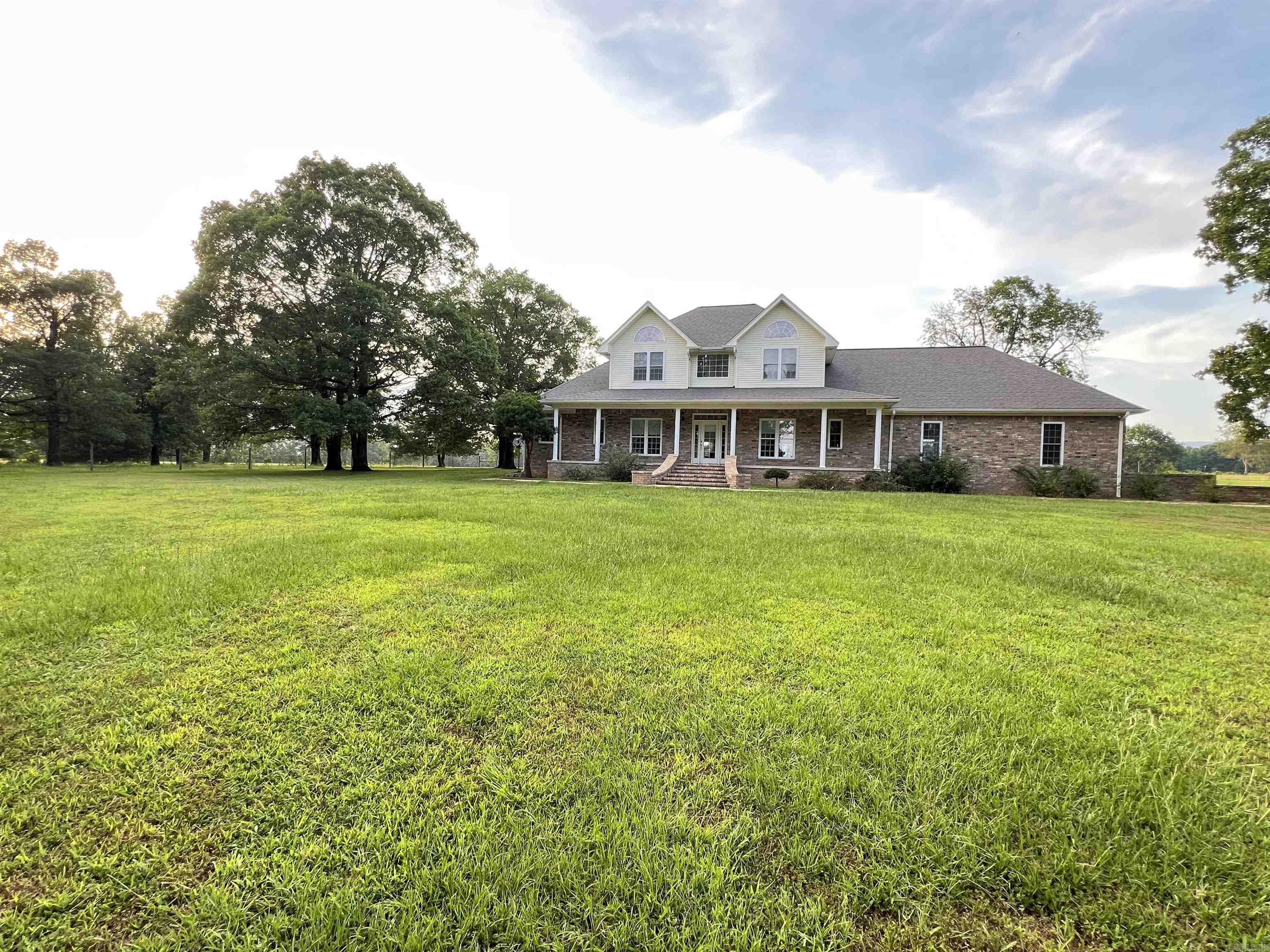 Looking for your dream home? This classy custom brick home sits on 248 acres with the perfect blend of cross fenced pastures and trees! The open floor plan features new laminate flooring throughout the lower level, Fresh Paint, NEW A/C unit, 18 ft. ceilings, built in oak book cases and cabinets, double hung windows, and a pellet stove with 20+ bags of pellets. The kitchen boast a double oven, a wall oven, a stunning blue sink, and plenty of cabinets! The pantry/laundry room is equipped with a double sink, tons of storage, BRAND NEW refrigerator, and a full bathroom! The primary suite is on the main floor, with 3 bedrooms on the lofted second floor. Additional features include a formal dining room, breakfast dinette, office/piano room, 2 soaking tubs, whole home backup generator, a NEW security system, and a large 3 car garage. The home is being sold fully furnished, and includes some beautiful pieces! Step outside to the POOL and enjoy views of RICH MOUNTAIN as you relax. This secluded acreage includes 5 ponds, a hay barn, and a shop for equipment. This unique property has been enjoyed and adored by its original owners for decades. Don't miss out on this one of a kind oasis!