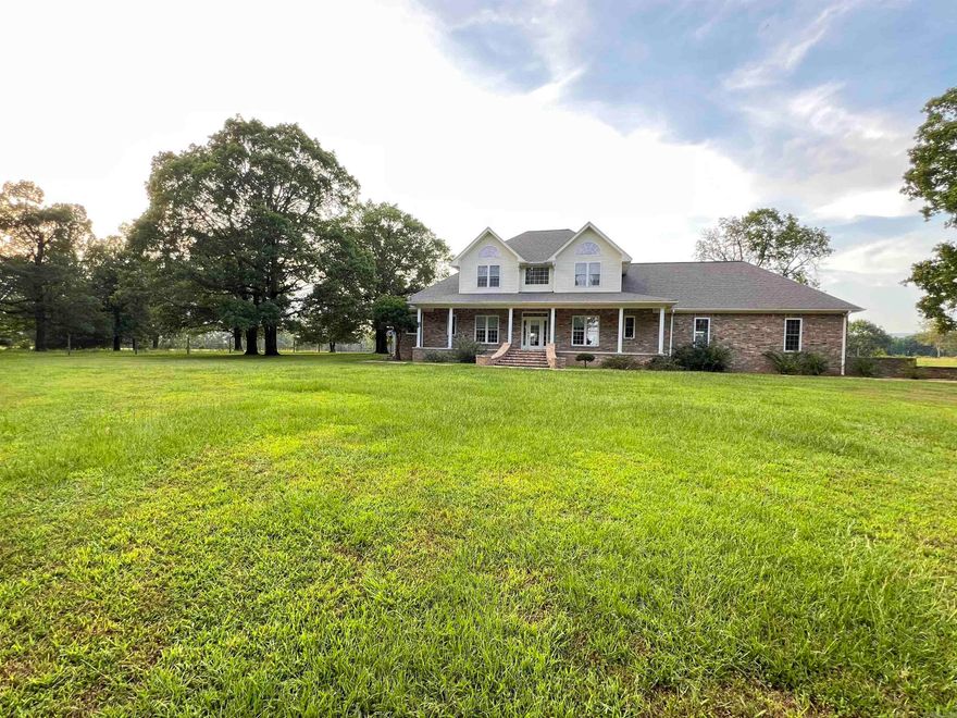 Looking for your dream home?  This classy custom brick home sits on 248 acres with the perfect blend of cross fenced pastures and trees! The open floor plan features new laminate flooring throughout the lower level, Fresh Paint, NEW A/C unit, 18 ft. ceilings, built in oak book cases and cabinets, double hung windows, and a pellet stove with 20+ bags of pellets. The kitchen boast a double oven, a wall oven, a stunning blue sink, and plenty of cabinets! The pantry/laundry room is equipped with a double sink, tons of storage, BRAND NEW refrigerator, and a full bathroom!  The primary suite is on the main floor, with 3 bedrooms on the lofted second floor. Additional features include a formal dining room, breakfast dinette, office/piano room, 2 soaking tubs, whole home backup generator, a NEW security system, and a large 3 car garage. The home is being sold fully furnished, and includes some beautiful pieces!  Step outside to the POOL and enjoy views of RICH MOUNTAIN as you relax.  This secluded acreage includes 5 ponds, a hay barn, and a shop for equipment. This unique property has been enjoyed and adored by its original owners for decades. Don't miss out on this one of a kind oasis!