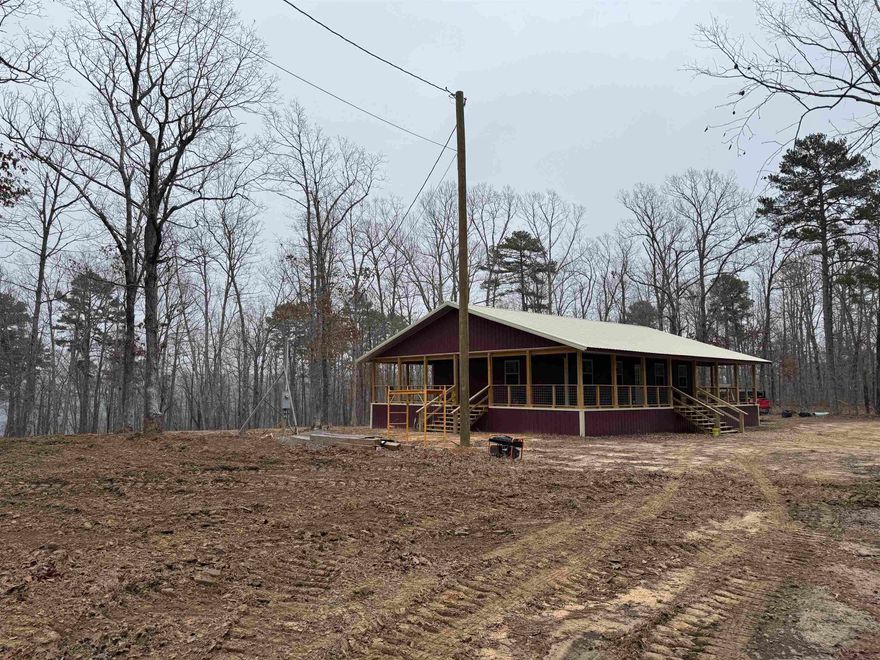 Outdoor enthusiast's, have we got the place for you! This 640 +/- acre tract located in southern Stone County offers breathtaking views and unparalleled privacy. The newly constructed 1,200 square foot home (3,000 square feet under roof) features 3 bedrooms, 1 bathroom, city water, electricity, fiber optic internet, and central heat and air. The wrap-around porches are perfect for enjoying the peaceful surroundings. Tick Creek flows for approximately 2 miles through the property, offering beautiful sites for exploring, swimming, picnicking, or simply unwinding. The rock formations and water color are a must-see, and most are easily accessible by 4x4 vehicle. The property boasts a well-laid-out trail system, allowing access to nearly all of the property by 4x4, ATV/UTV, or horseback. The trails wind through the hills and along the creek, making for easy exploration. There's even a lookout point with a view that words cannot describe! The current owner has been practicing select-cut hardwood harvesting along the creek bottom, creating food plots and enhancing the wildlife habitat. The timber harvesting has been done carefully to avoid damage to the property.