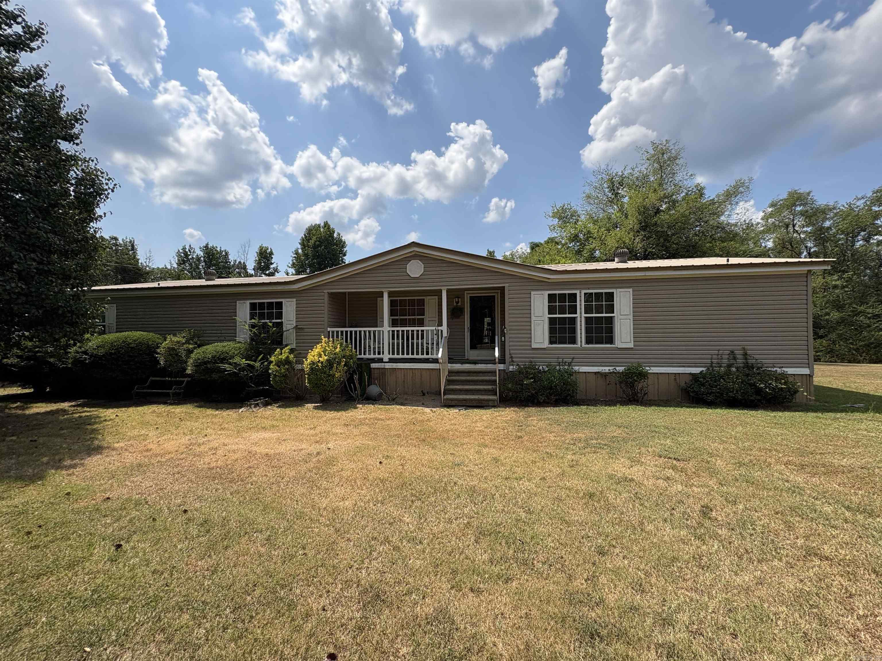 Enjoy wide-open spaces and peaceful living in this 3-bedroom, 3-bath double-wide mobile home on 5 beautiful acres! Built in 2001, this home offers a giant master suite with his & her bathroomsāone with a luxurious jacuzzi tub, the other with a walk-in showerāplus huge closets for all your storage needs. The spacious dining room and open kitchen are designed for hosting everything from holiday dinners to casual weekend get-togethers. With plenty of room inside and endless space outdoors, youāll have the perfect blend of privacy, comfort, and country charm. Bring your dreams, your hobbies, and your love for the great outdoorsāthis property is ready to make them a reality! Outside theres covered parking and a 10x12 shed for storage needs.