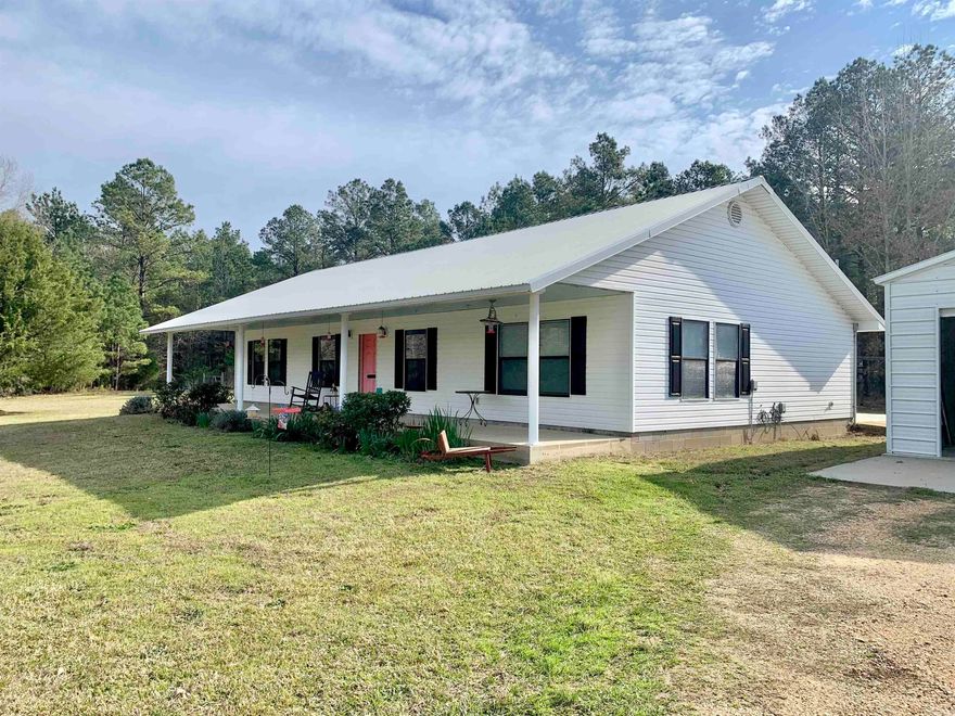 Welcome to this charming 3-bedroom, 2-bathroom home with an inviting open floor plan and vaulted ceilings that create a spacious and airy ambiance.  This home features a split bedroom floor plan with an oversized master suite with his and hers walk-in closets. The master bathroom is a luxurious retreat, boasting a walk-in shower, large soaking tub, and dual sink vanity, perfect for unwinding after a long day.  Other highlights of this property include a convenient laundry room, an outbuilding for additional storage, and a versatile shop/garage with three overhead doors, perfect for hobbies or extra vehicles.  Situated on three acres of mostly fenced land, this property offers ample space for outdoor activities and peaceful enjoyment of the surroundings.  Recent updates include a new roof, HVAC system, and garage in 2022, as well as a double oven stove and dishwasher also installed in 2022. The new fridge, which conveys with the property, was added in 2023. Additionally, both bathrooms were refreshed with new vanities and toilets in 2022.  Don't miss out on the opportunity to make this beautiful upgraded home yours!