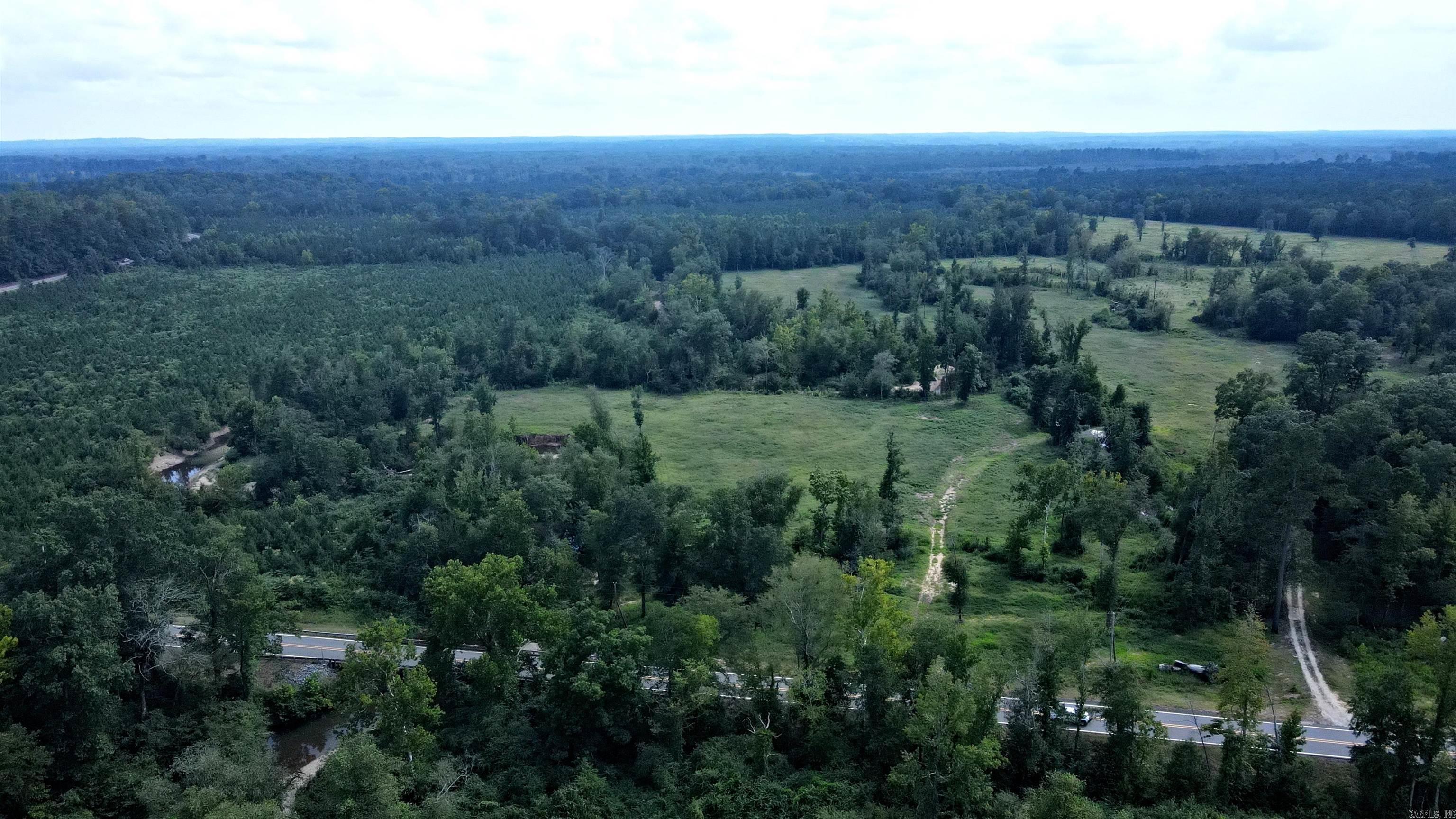 WIDE OPEN SPACES AWAITS YOU whether you are building your next dream home, starting a farm, or simply love to enjoy the outdoors! This BEAUTIFUL 54.89 acres with ~ NEWLY ADDED 30 X 40 BARN~ with plenty of pasture, wooded area, running stream YEAR ROUND to water the livestock, also gravel bar and fishing spots. Great for cattle, horses, or other livestock! Tons of recreational opportunities in the perfect location just minutes from I-30 in Clark County, Arkansas. The land has excellent fertile pastures for animals to graze along with harvesting hay. Seller is averaging 5 bales of hay per acre, on his last cut. Some areas of the property may be in the flood zone. Did I mention the deer and turkey hunting? Make your own personal family retreat and hunting oasis! CALL TODAY!