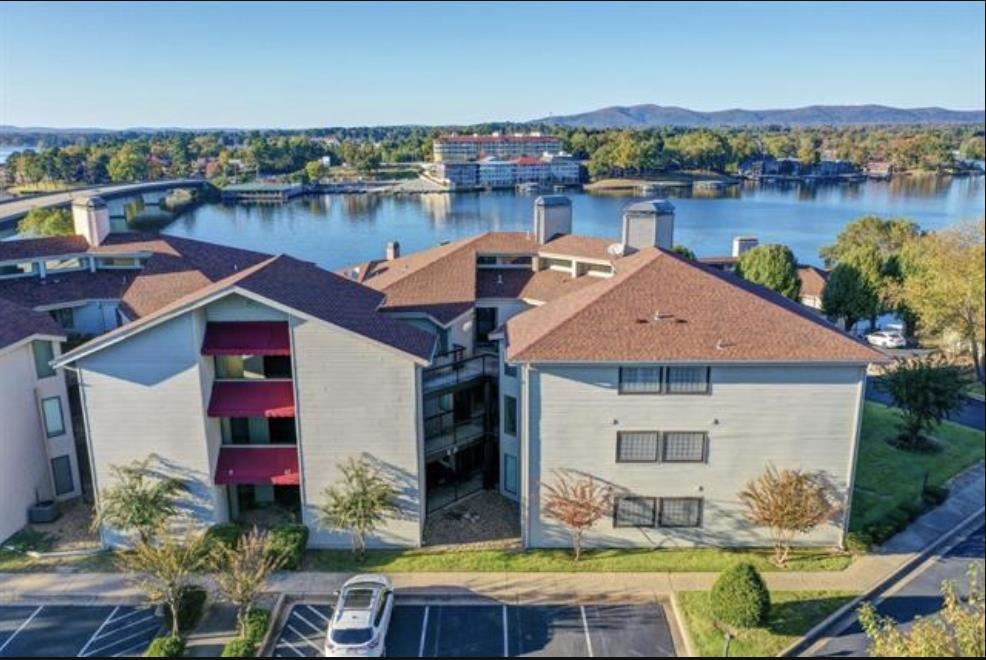 A rare gem that is priced to sell. Perched on the tranquil shores of Lake Hamilton. This immaculate upper-level condo is a masterpiece of comfort and charm. With elevator access, stunning water views and your very own boat dock, this property is a sanctuary for relaxation and adventure. Whether you envision it as your permanent residence or an income-generating short-term rental, it comes fully furnished and ready to welcome you! This stunning property offers exclusive access to top-tier amenities, including a sparkling swimming pool, a stylish clubhouse for gatherings, a relaxing hot tub, and a rejuvenating sauna. Unwinding after a long day or entertaining guests, this community is designed for comfort, luxury, and everyday relaxation. Don't wait to make it yours! Call today to schedule your private showing.
