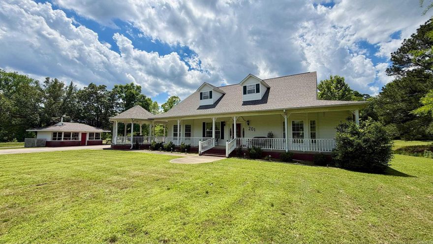 Welcome to 201 Green Willow Lane, a spacious two-story home on 1.6 acres accessed by a private driveway with lovely views of the surrounding property. Offering 3,533 SF with 3 bedrooms and 4 bathrooms, this home delivers the space, privacy, and comfort of true country living. The living room features an elegant tray ceiling and a gas log fireplace, creating a warm and inviting gathering space. The kitchen is equipped with granite countertops, and a thoughtful mix of hardwood, carpet, and tile flooring flows throughout the home, adding character to every room. Abundant storage throughout ensures there is a place for everything. A wraparound covered porch spans the front and side of the home, while a second covered porch on the rear provides even more outdoor living space to take in the views and enjoy the surroundings year-round. A detached workshop adds real versatility for woodworking, hobbies, or organized storage. Situated on a peaceful 1.6-acre lot with convenient access to dining, shopping, Lake Hamilton, Oaklawn, Garvan Gardens, and all that Hot Springs has to offer. Agents, see remarks.