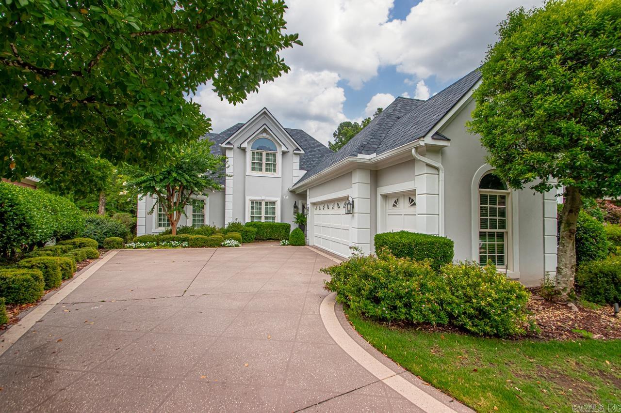 Welcome inside this light-filled home located on the 1st fairway of Chenal Country Club's Founders Course, just steps away from the Country Club. Gleaming hardwood floors, new interior paint, deep crown moldings, stainless appliances, pretty light fixtures, newer windows and new roof in 2024 are just a few of the wonderful amenities. The primary suite has a fireplace and French doors that open onto a deck overlooking the course and water feature. The 2 story great room has a fireplace, built-in shelving and a bar located behind closed doors. The Formal Dining room looks onto a courtyard with a water feature. Upstairs are 2 additional bedrooms, an office and full bath. 2 car garage plus a golf cart garage, lawns maintained by POA and gated entrance make this a great home to entertain in and just ENJOY LIFE. Come take a look.