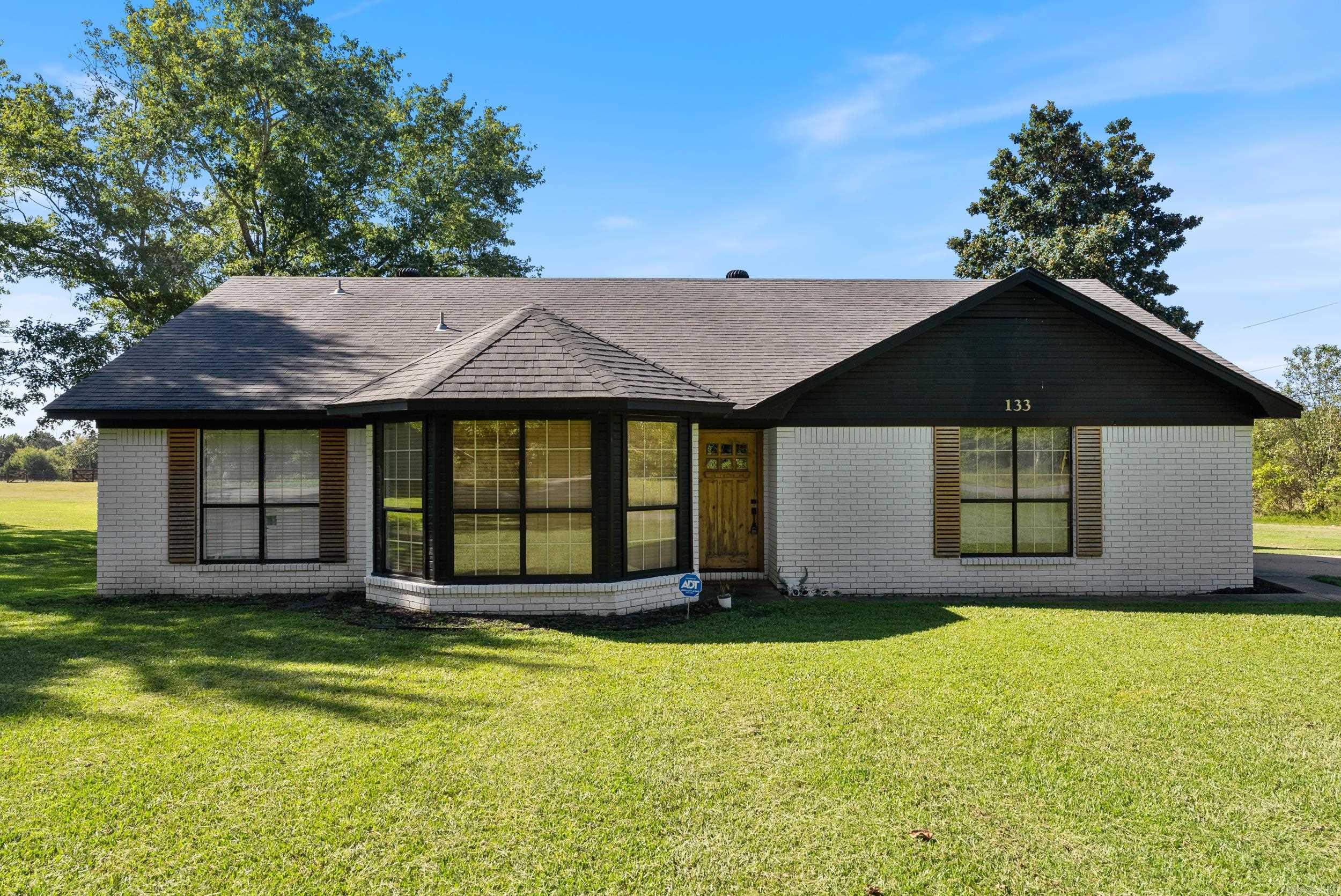 A beautifully remodeled home on 1.10 acres with a shop and close to the city. What more could you ask for? Walk in to a gorgeous and modern tiled entry that leads to beautiful luxury vinyl flooring throughout the living room and all the bedrooms. Perfect split floorplan with the primary bedroom set apart from 2 guest rooms. The primary BR features a unique bed and closet design for added space and one of the guest rooms includes built in cabinets for extra storage. A large living room with an inviting woodburning fireplace will be cozy for those upcoming cool fall/winter evenings. You will enjoy cooking and gathering in the updated kitchen featuring concrete countertops, gold farmhouse sink, updated cabinets and a pantry. Both bathrooms have solid surface countertops with updated flooring, toilets, sinks and faucets. Updated lighting complete the look throughout the home. There is a back deck and patio with hot tub included! Great outdoor storage with a shop that includes electric and shelving. AGENTS SEE REMARKS.