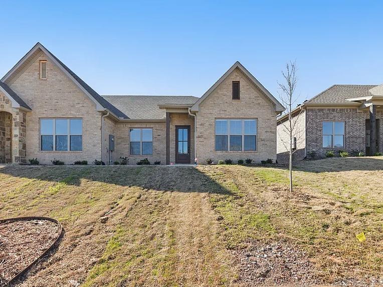 Welcome home to West Little Rock's latest destination for luxury living, Edgewood! Surrounded by lush landscaping and mature trees, the Edgewood community provides a secluded atmosphere while being just moments away from your favorite shopping and dining spots in West Little Rock. Another perk of this desirable neighborhood? NEVER MOW YOUR LAWN AGAIN! Lawn maintenance is included with your yearly fees! This unit has 2 bedrooms, 2 full bathrooms. Fully loaded chef's kitchen includes walk-in pantry, central island and opens to spacious living room with built in fireplace. Master Suite includes high vaulted ceilings and the spa like bathroom which has a walk-in shower with walk-in closet. Laundry Room, Two Car Garage and covered back patio accessed off the private drive. Get in now to customize interior selections~ (Tile, paint, lighting, flooring, etc) This unit is under construction. The photos are a replicate of the layout but the exterior/interior colors will be different. ETA completion December.