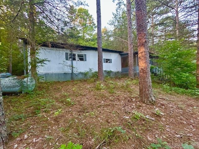Almost 4 acres m/l with highway frontage. This property has 2 older mobile homes on it that could be fixed up. There is a pond, power, water, septic and a well and 2 propane tanks on the property. Great place for a hobby farm or your nice private place to call home and build your forever home. Both of these mobile homes could even be fixed up for rentals. You could even live in one and rent the other. Lots of possibilities! Call to schedule your appointment today!