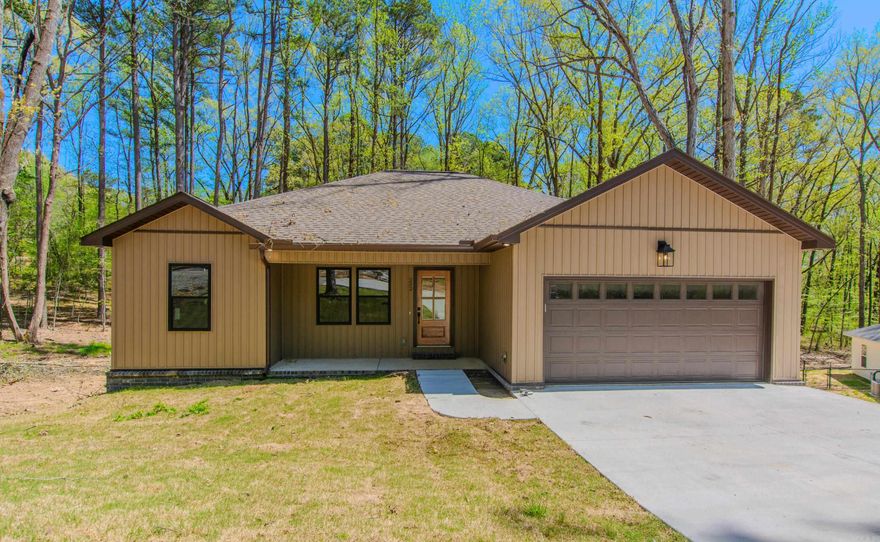 Wonderful new construction in Bauxite.  3 bd 2 ba. Great room has electric fireplace.  LVT flooring. Granite in kitchen. Large island work space and breakfast bar.  Split bedroom plan.  Walk-in closets. Covered back porch backs up to wooded area.  Street will be paved once construction is finished. One acre lot.  Bauxite schools. Backs up to trees.