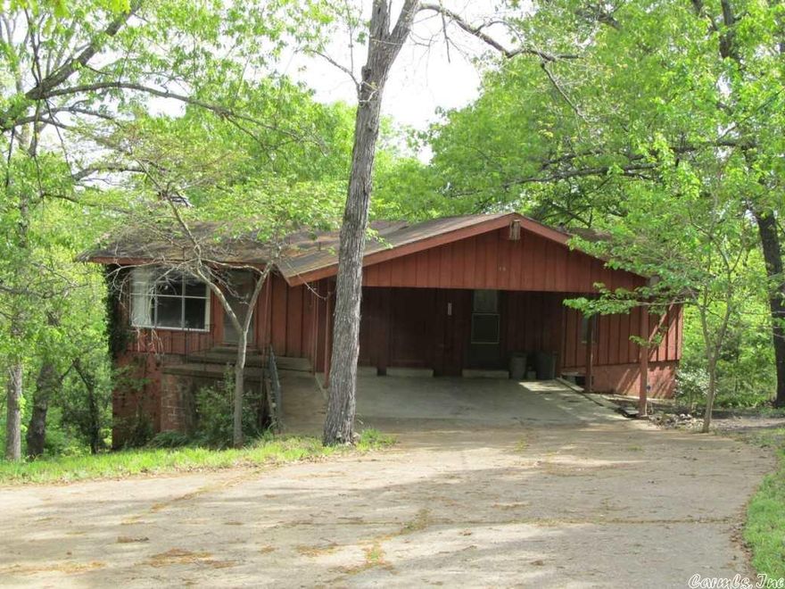 Classic "Fixer Upper" this home has potential for any do-it-your-selfer. 1000 square feet up, 880 square feet down, 3 bedrooms, one full, one three-quarter and one half baths, large living room, 2 fireplaces, large family room, a double carport and 2 lots. Don't be afraid to look at this one priced at only $28,500.00 O.B.O.