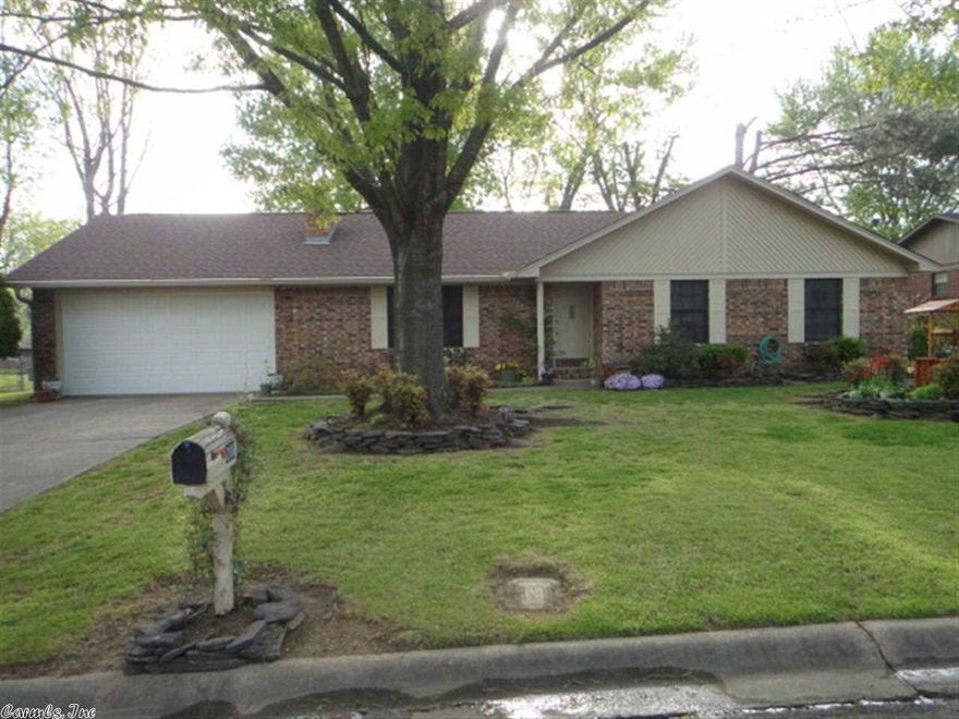 Beautiful, well-maintained piece of paradise in the heart of Searcy. Vaulted living room showcases a wall fireplace (with blower) and built in bookcases.  Nice shaded backyd surrounded with custom built privacy fence. Custom watering system makes landscaping easy in the front & backyd. Includes a large raised garden plot. Wired 10x20 storage shed. Heated and cooled two-car garage. All new laminate flooring and new central heat and air system.  See attached document for list of updates and improvements.