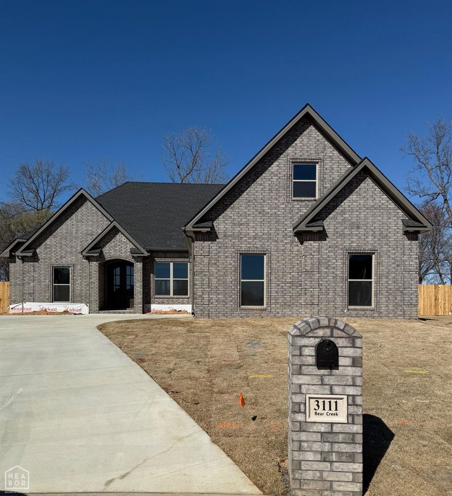 Welcome to this exquisite home at 3111 Bear Creek Cove, built by the local builder Mark Morris Construction. This all-brick beauty offers a perfect blend of style, comfort, and quality craftsmanship. Featuring an open floor plan with 4 spacious bedrooms and 3 bathrooms. Step inside to discover luxury vinyl plank flooring in the main living areas, complemented by ceramic tile in the bathrooms and laundry room for durability and elegance. The heart of the home includes a cozy gas log fireplace, and a beautiful kitchen complete with a gas range, dishwasher, garbage disposal, pantry and backsplash. Additional highlights include a dining room, master bathroom has a glass shower door and separate tub, large closet, custom closets for maximum storage, a tankless gas water heater, Spray foam insulation, and a custom metal stair railing for a touch of sophistication. The stunning wood front doors invite you in, while the screened-in back porch offers a landscaped patio. Convenience is key, with gutters installed on the front of the house and modern touches throughout. Don't miss the opportunity to make this exceptional property your forever home.