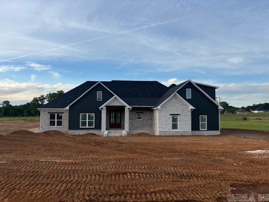 Stunning new construction home blending modern design with timeless craftsmanship. This open-concept layout features spacious living areas filled with natural light, soaring ceilings, and beautiful exposed wood beams that add warmth and character.  The gourmet kitchen is the heart of the home, showcasing custom cabinetry, a large center island, and ample space for cooking and entertaining. The living and dining areas flow seamlessly, with expansive windows and sliding glass doors that bring in scenic views and create an inviting indoor-outdoor feel.  Enjoy wide-plank flooring, designer finishes, and thoughtful details throughout. The home also offers well-appointed bedrooms and stylish bathrooms, including a spacious primary suite.  With striking curb appeal, plus a covered outdoor area perfect for relaxing or hosting, this home delivers comfort, style, and the benefits of brand-new construction.