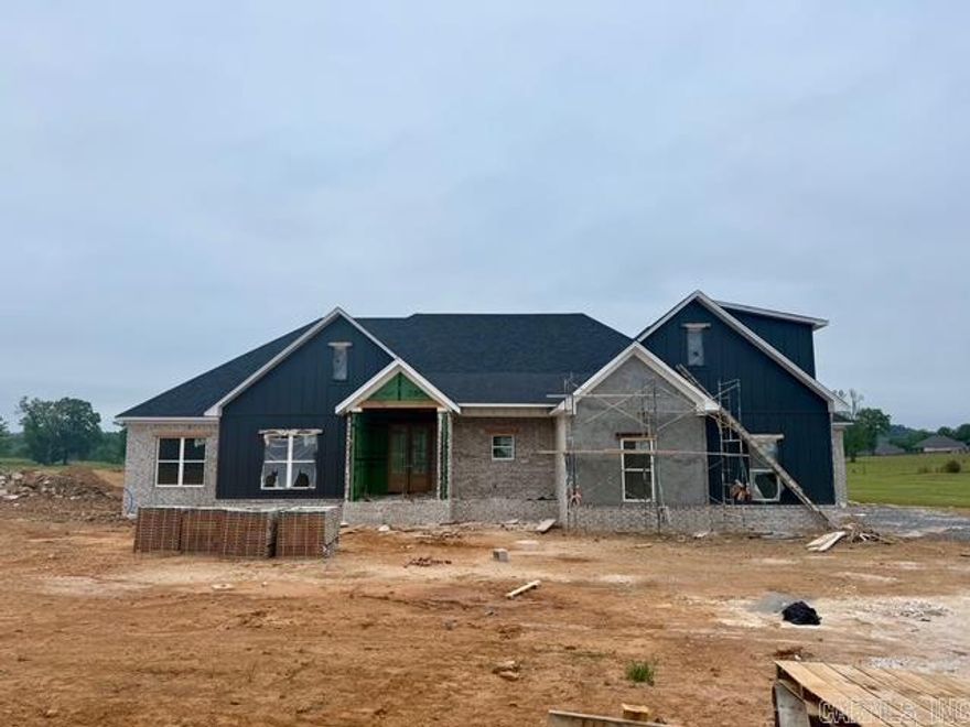 Stunning new construction home blending modern design with timeless craftsmanship. This open-concept layout features spacious living areas filled with natural light, soaring ceilings, and beautiful exposed wood beams that add warmth and character.  The gourmet kitchen is the heart of the home, showcasing custom cabinetry, a large center island, and ample space for cooking and entertaining. The living and dining areas flow seamlessly, with expansive windows and sliding glass doors that bring in scenic views and create an inviting indoor-outdoor feel.  Enjoy wide-plank flooring, designer finishes, and thoughtful details throughout. The home also offers well-appointed bedrooms and stylish bathrooms, including a spacious primary suite.  With striking curb appeal, plus a covered outdoor area perfect for relaxing or hosting, this home delivers comfort, style, and the benefits of brand-new construction.