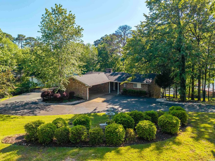 Tucked away on a large 1-acre waterfront lot, this fully remodeled and furnished lake home delivers the ultimate blend of privacy, convenience, and income potential. Offering 4 bedrooms, 3 baths and 2,648 sq. ft., the home features vaulted ceilings with exposed beams, brick fireplace and an open living area designed around the spectacular lake views. The updated kitchen includes quartz countertops, oversized island seating and modern finishes throughout. Outside, enjoy mature trees, professional landscaping, expansive outdoor living space and a covered boat dock in a quiet cove setting. The active short-term rental license adds exceptional flexibility for personal use or investment purposes. The lot will easily accommodate a separate guest house or large shop building.