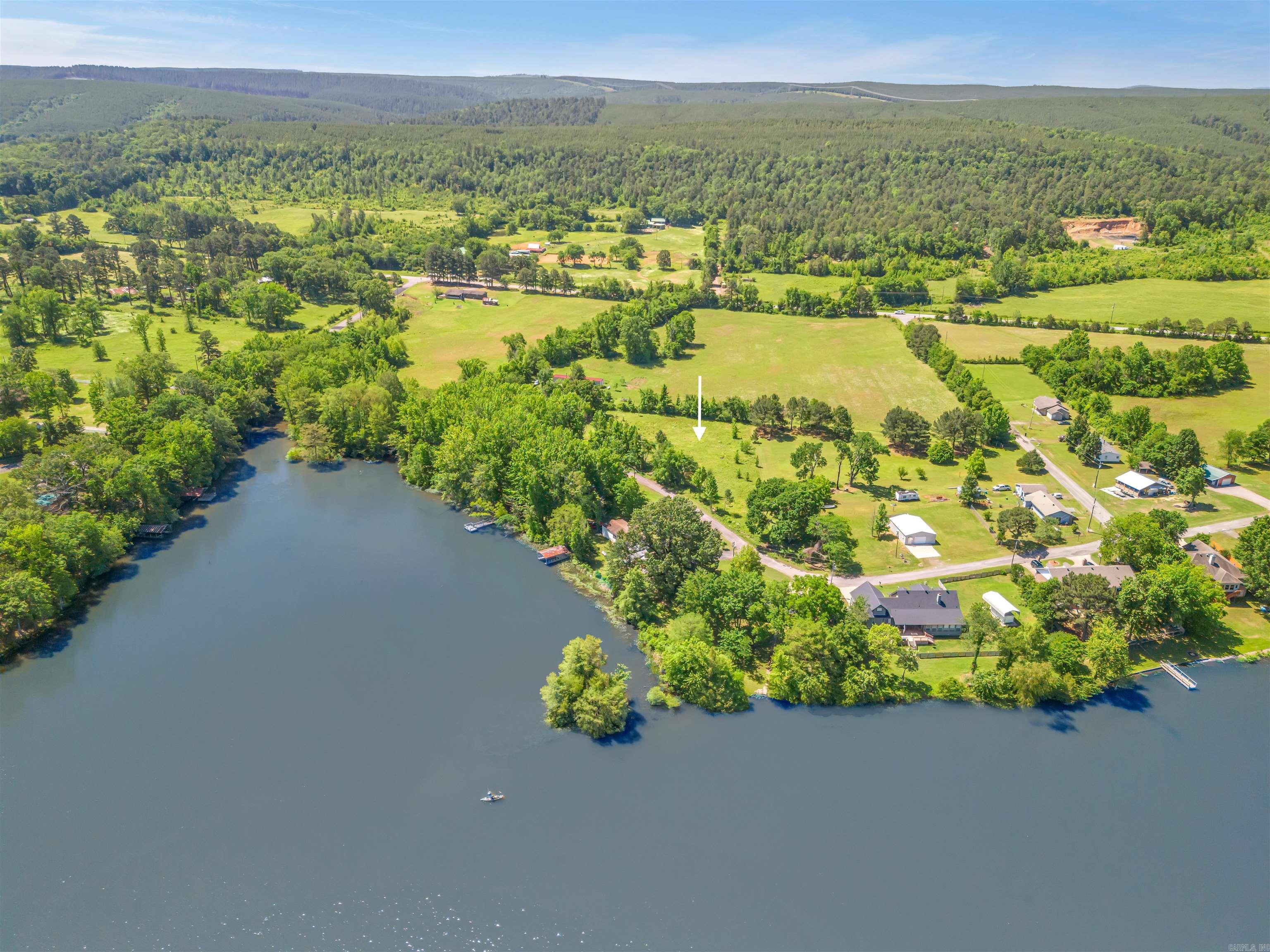 Beautiful lot right beside Harris Brake Lake! This listing is for 0.74 acres. The land is flat and buildable. City water at road. Will need state-approved septic. First Electric Coop is the area electricity provider. Connect2First provides Fiber Internet! Double wide mobile homes that are permanently affixed are allowed per the subdivision covenants. There is a dirt boat ramp right across the road from this lot. This property is situated near the Ouachita National Forest and Harris Brake Lake WMA. Enjoy everything rural Arkansas has to offer! This lot is also available with the adjoining .33 acres. There is a combined listing for both lots (Tract 2 & 3 Lakeview Rd).