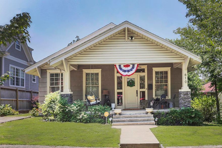 Updated Hillcest bungalow with loads of charm!  Pretty front porch with a swing and two car parking pad.  Large open living room/dining room with lots of windows.  Remodeled kitchen with granite countertops, craftsman style cabinets, stainless steel appliances, gas cooktop and walk in pantry.  Primary bedroom with attached bathroom featuring double vanities, walk in shower and spacious walk in closet with washer and dryer.  2 additional bedrooms with nice closet space.  Beautiful hardwoods and custom blinds throughout.  Off of the kitchen is a mudroom leading to the covered deck in the back with doggy door.  Detached garage/workshop with rear alley access.  Fully fenced backyard.  Walking distance to all of the Hillcrest restaurants and shops.  New Roof 2023!