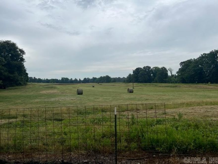 Welcome to this exceptional cattle farm property that offers everything you need to run a successful operation. This fully fenced property with cross fencing is located less than a quarter mile down a gravel road, providing privacy and easy access. The farm features a range of amenities designed to streamline cattle handling and maximize efficiency. Located on the property is a spacious 60x100 pole barn, which includes a maintenance shop and an office in the front. The barn is equipped with a cattle working facility featuring steel pipe fencing, a sweep, and a head chute, ensuring safe and efficient livestock handling. Additionally, there is a semi load-out area for convenient transportation of livestock.    Water accessibility is crucial on a cattle farm, and this property boasts two automatic freeze-proof water sources.  One is located inside the barn, ensuring year-round hydration for your animals. There is also another automatic water source located in the feedlot, providing ample water supply throughout the property.  The barn also offers a 10-foot lean-to for storage, providing additional space to store equipment and supplies, further enhancing the functionality of the farm.