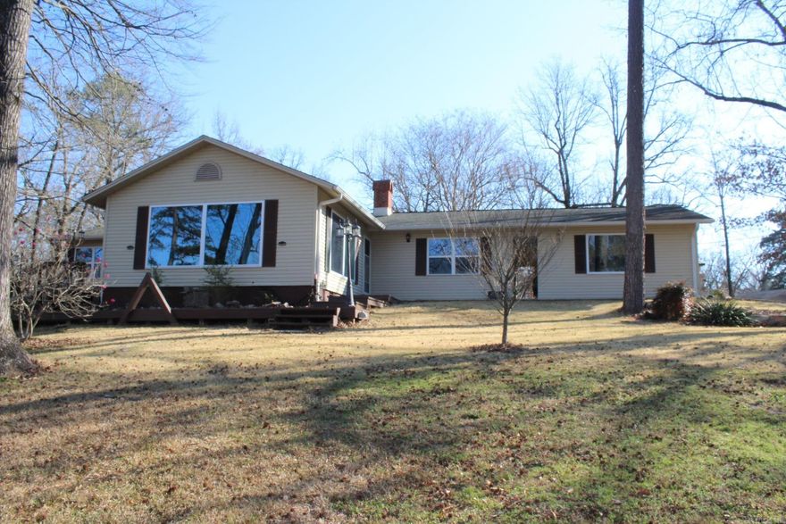 2 Bedroom, 2 Full Baths with approx. 2226 Sq. Ft. of living space situated on approx. 6.90 wooded acres with a large pond. Spacious kitchen with granite counter tops and great storage (gas range conveys with sell of home).  Home has a large formal dining area.  Both baths are very large with walk in showers. Rear of home features a large covered deck with great views of the pond.  2 car attached garage and a 2 car detached carport.  Property has a separate approx. 800 Sq. Ft. Cabin and several outbuildings and Storm Shelter.  Home has a Vanguard back up generator.