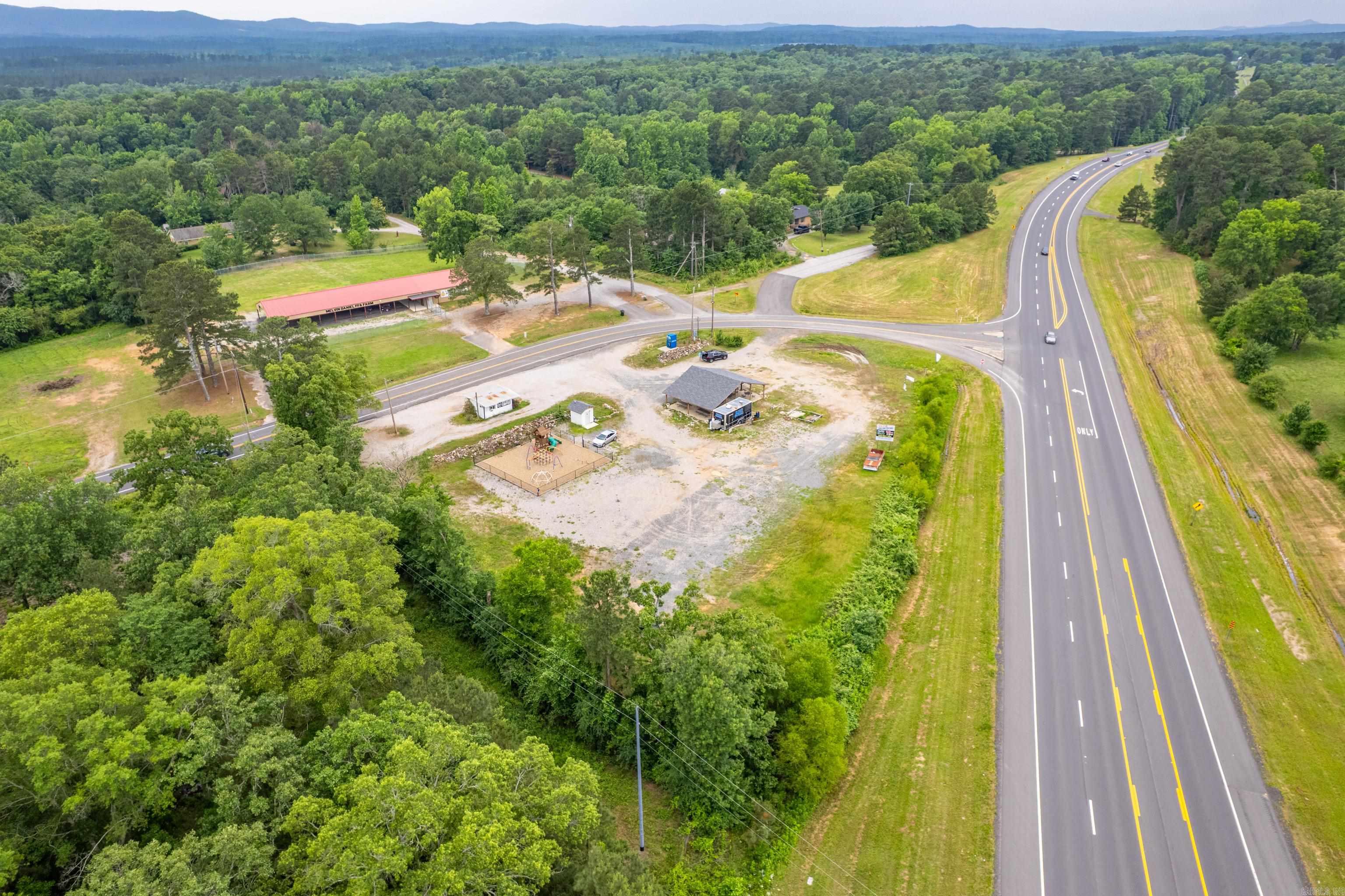 Exciting opportunity to own a 1.44 acre food truck court in a high growth area. This property is fully equipped and ready for business with four 250-amp hookups for food trucks, making it ideal for a thriving mobile dining destination, Highlights include: A spacious 50x50 covered gazebo with ample seating, a playground area for kids-a great family friendly draw, plenty of parking space to accommodate large crowds, prime location just minutes from Lake Hamilton School, ensuring steady customer traffic and public restroom. Whether you're a food truck operator looking to expand or an investor seeking a unique commercial opportunity, this property offers everything you need to get started right away.