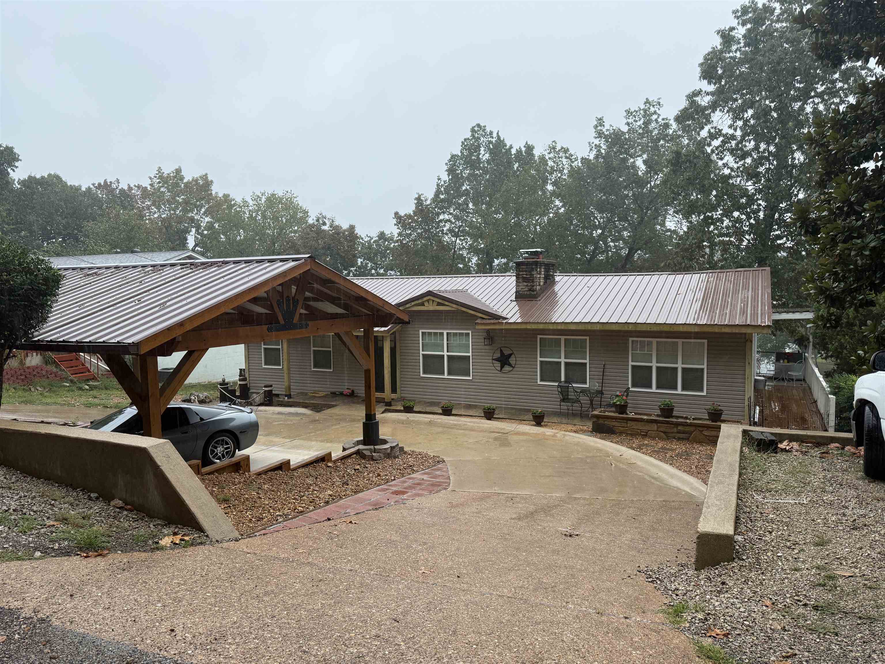 This lake home has been beautifully refurbished and will be rented fully furnished! Concrete circle driveway leads into the covered 2-car carport. Furnished livingroom has a flatscreen tv and a wood burning fireplace. 3 bedrooms on main level and 1 bedroom in the basement. Wake up to a beautiful view of Lake Sequoyah from the master suite. Enjoy a cozy wood fire in the rock fireplace and soak in the oval free-standing bathtub. One of the other guest bedrooms also has a lake view. Kitchen has a side-by-side refrigerator, flat-top stove with oven, dishwasher & microwave. Guest bathroom has been updated with a beautiful tiled walk-in shower. The wrap-around deck leads down to the basement where there is a washer & dryer, bathroom with a walk-in shower and bedroom with a bunkbed. Steps lead down to the dock and a firepit on the bank of the lake. 1272 sqft on main level & 208 sqft basement. $39 will be added to the rent to cover pest control, liability insurance and credit reporting services. Each adult must complete an application.