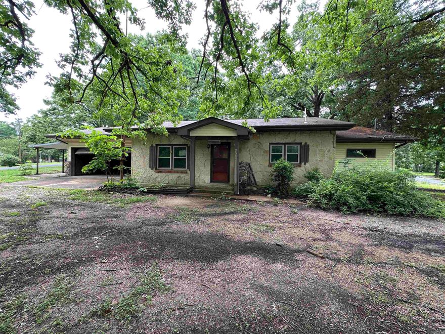 Discover a property with exceptional potential in the heart of Lakeview. Located just minutes from Bull Shoals Lake access, this spacious setting offers the ideal opportunity for anyone looking to create a personalized lake area retreat or investment property. The home sits on a large, usable lot, providing room to expand, garden, or simply enjoy the peaceful surroundings of the Ozarks. The main residence features 3 bedrooms and 2 bathrooms, offering a functional layout with plenty of space to reimagine. In addition to the primary home, the property includes a detached living area equipped with 1 bedroom, a half bath, a living room, and a kitchen, perfect for guests, extended family, or potential rental income. This added flexibility makes the property especially appealing for buyers seeking multi use living arrangements or creative renovation possibilities. A 2 car attached garage provides secure parking and convenience, while multiple storage areas throughout the property!
