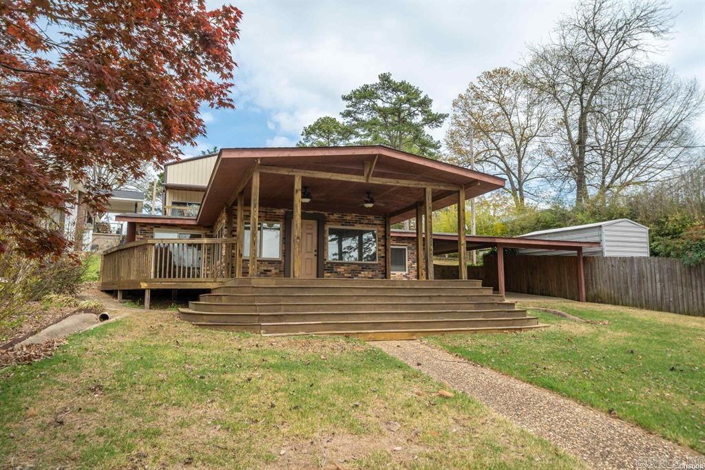Discover this charming one-level brick lakefront home, perfect as a cozy weekend retreat, a lucrative Airbnb, or a serene full-time residence. Boasting three bedrooms and one and a half baths, this cozy gem offers both comfort and convenience. Enjoy breathtaking lake views and effortless water access with your very own floating covered boat slip, boardwalk, and lakeside patioāideal for fishing, boating, or simply unwinding. Recent updates include new energy-efficient windows, a sleek patio door, and modern appliances. Climate control is a breeze with central HVAC and an additional mini-split system, ensuring year-round comfort. Gather around the inviting brick fireplace with gas logs for cozy evenings. Step outside onto the expansive covered deck, perfect for entertaining or simply soaking in the tranquil lakeside ambiance. The property also features a detached 30' x 42' two-car RV or storage building with impressive 16-foot high walls, two oversized 14' x 12' overhead doors, two patio doors, and its own covered deck with impressive lake views. With plans to convert the upper level into loft-style living quarters, this space is brimming with potential. Additionally, a 12' x 24' w