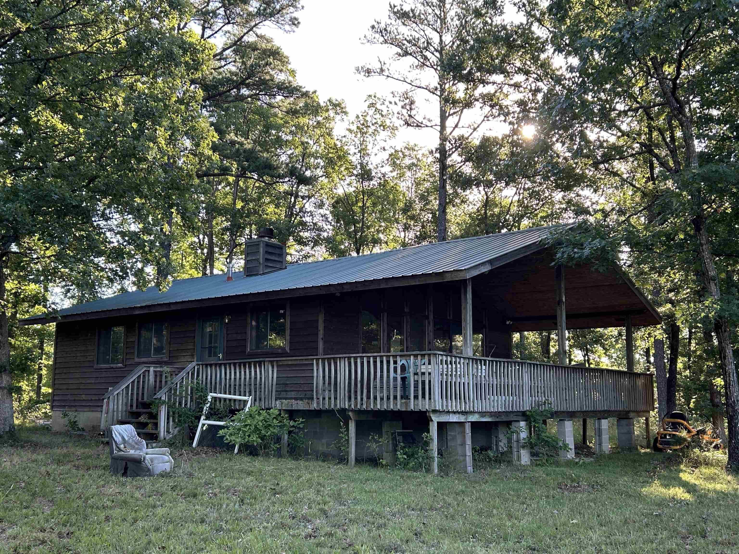 The 4 Springs at Six Ridge is a stunning 120-acre property located in one of the most remote areas of Arkansas, situated 20 miles away from the nearest town by road. This property is the definition of "OFF THE GRID". The main cabin overlooks the pond and features newer metal roof, wood-burning fireplace, hardwood floors, covered walk out deck, sheet rock walls, and lots of windows providing ample natural lighting. The main cabin also includes a generator and generator house, ensuring a reliable power source even in this remote location. There is a secondary cabin also on this property that also features a new metal roof presenting an opportunity for renovation and customization. Other property features include Large 1.5 acre pond dug extra deep with 3,500 catfish, 3,000 bream, and 1,500 red-ear bream stocked several years ago, large pasture or food plot, 4 different natural springs, 1 dug well and 1 spring well supply water providing you an endless supply. The acreage features a mixture of tree types, creating a picturesque natural setting. With its secluded location and serene natural surroundings, the 4 Springs at Six Ridge is ready to become yours today. Scheduled showings only