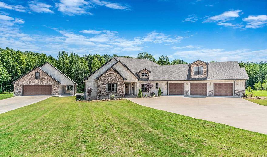 Welcome home to this beautiful custom build in Jacksonville! Tucked away in a sprawling gated subdivision, this home sits on almost 5 acres that backs up to the Holland Bottoms Wildlife Area. Living space features beautiful brick walls and fireplace, with the perfect flow into both formal dining and kitchen spaces. Primary bedroom is an oasis of calm with a spacious bathroom and HUGE closet. On the other side of the house are three large additional bedrooms, each with a walk-in closet. The fifth huge bedroom is upstairs with its own walk-in closet and full bathroom.  Walk outdoors to an exterior fireplace on a covered patio, overlooking the brand new 14'x28' inground pool! Looking to have guests over? This property boasts a total of five garage spots, as well as a guest house connected to two of the garage spots. Come take a look at this house soon! AGENTS SEE REMARKS.
