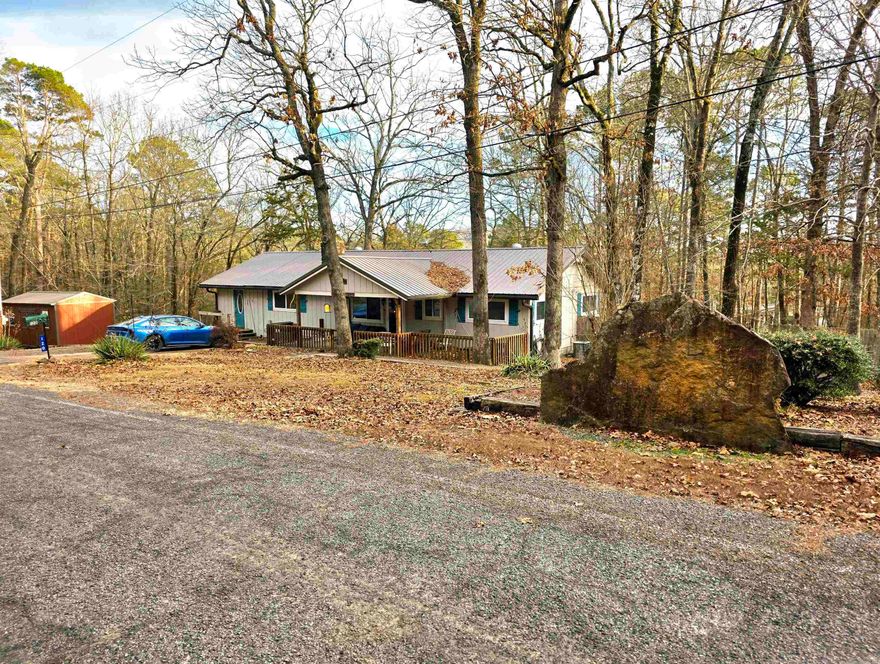 Just wow!!! This home has so much to offer for a lake area home in the amazing Fairfield Bay community. Right at half a mile to local boat launch/lake access!! The home and huge shop sit on 4 lots that have been replated to total 1.13 acres m/l. The shop is a 30x50 building with a 10x14 garage door with automatic door opener. Parking on side of shop that could fit an RV. Metal roof on home is approximately less than 10 years old. Serene, fenced in back yard that has the perfect spot for barbeques and enjoying the private, relaxing hot tub. The screened in back porch is perfect for the cool summer nights here on Greers Ferry Lake. There is also a very new separate storage building in addition to the huge shop, meaning all lake things, boats, and anything else will have room. Wood burning fireplace in living room and granite counter tops in kitchen. The list is enormous of the things that Fairfield Bay has to offer: ATV trails, 2 golf courses, community pools, walking trails, mini golf, great restaurants, disc golf course, and the list goes on and on. Don't sit on this one, come see it for yourself.