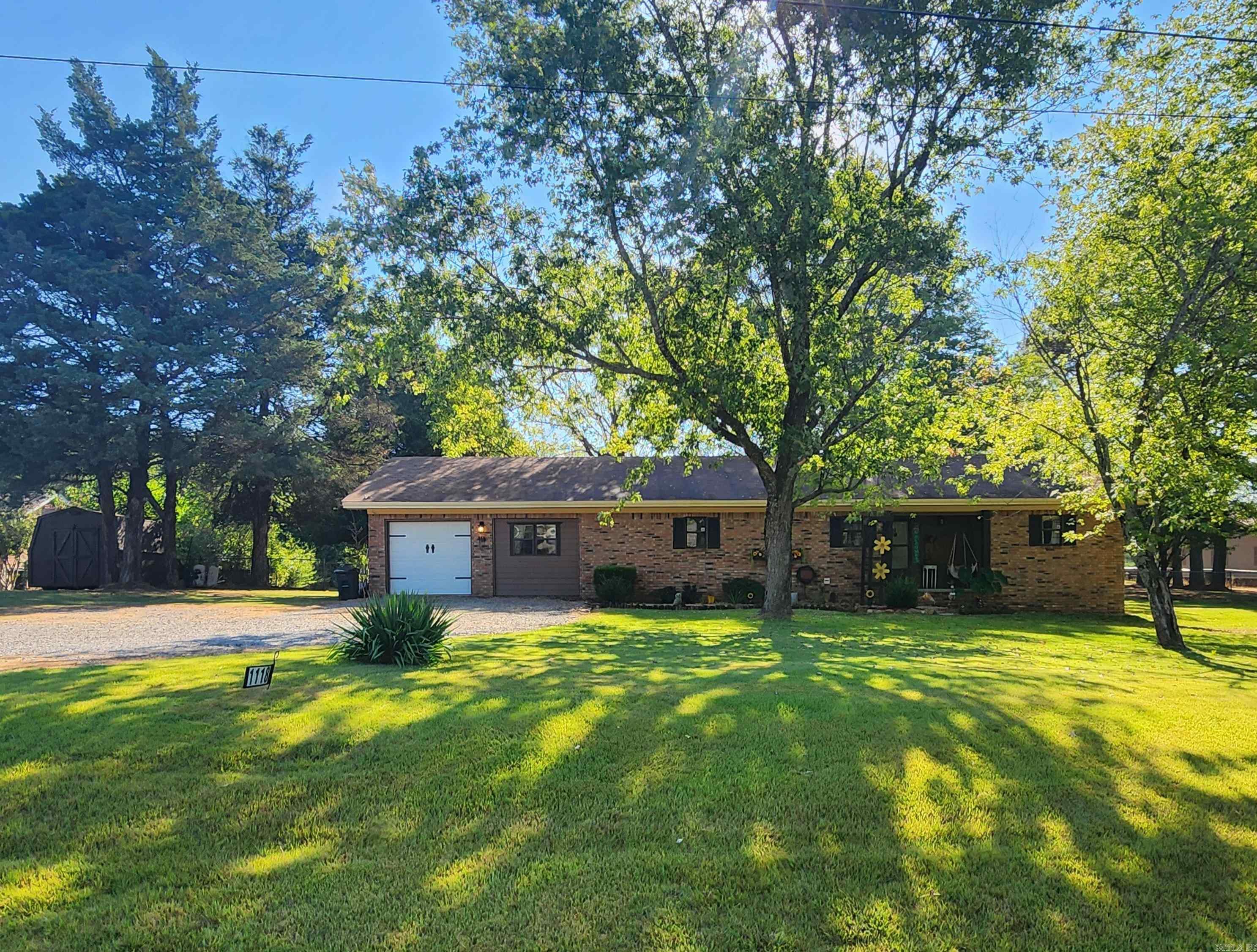 Nice all electric brick ranch house with almost 2 shaded acres very close to Judsonia & Searcy. This house has had a remodel including a 4th bedroom & closet. It also has a storage area behind garage that can also be used as an office or a bonus room. The kitchen has stainless appliances including refrigerator, lazy Susan, island with sink & a pantry & connects to dining area. The primary bedroom has 2 closets with a standup shower in the attached bathroom. Separate laundry room & a entry foyer leading to living room. There is also a separate driveway to the right of the house where a tiny house was previously located. It has a separate water meter & tied to septic. There is also a 30-amp electric plug to use as a RV site. Back yard is fully fenced, storage buildings stay & storm shelter outside back door. See agent remarks.