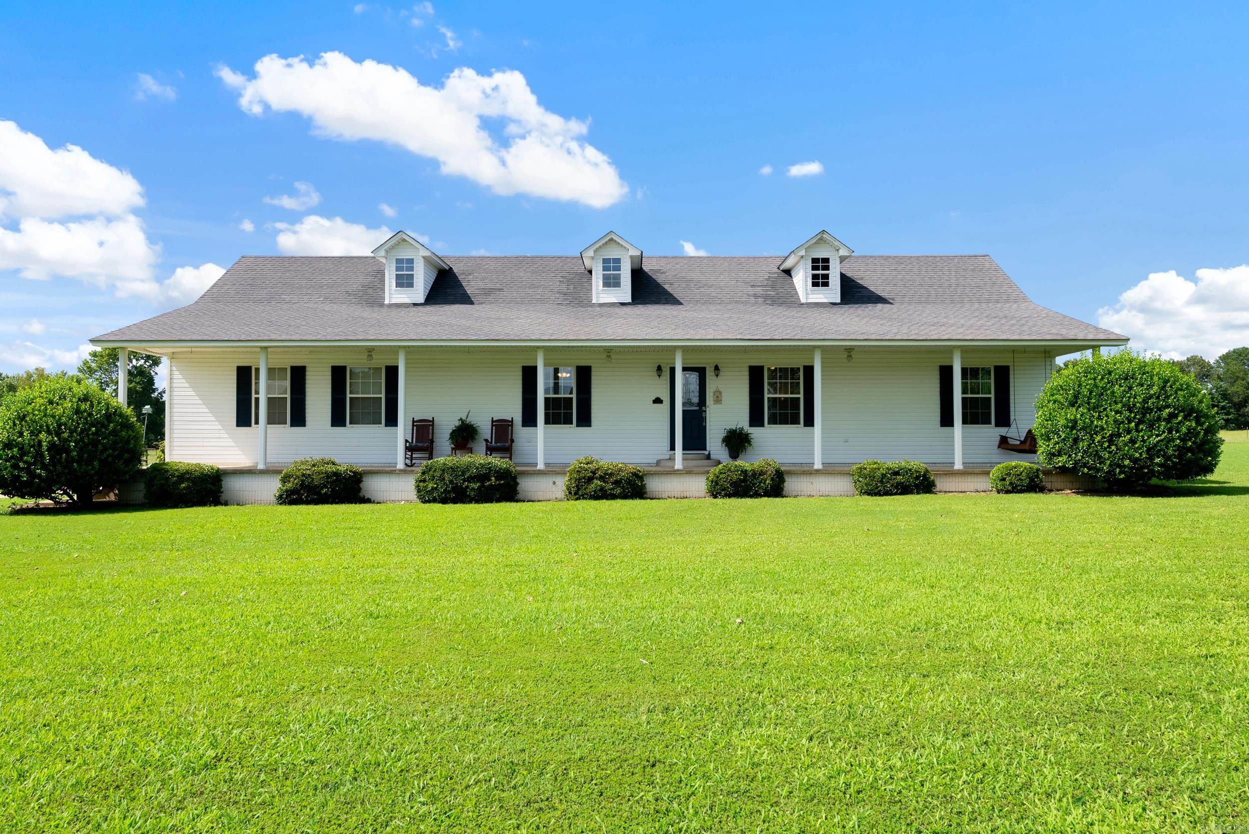Lovely one level home with a wonderful front porch that sits on 10.8 acres with a 5 stall barn. Living and dining room combo with updated eat in kitchen with granite counter tops and stainless steel appliances. Split bedroom plan and large laundry room off kitchen. New French doors off the dining area leading to a nice deck overlooking the pasture. Barn was built in 2003 and is 36 X 60 with 5 12x12 stalls, 24x24 hay area and 12x24 tack room.