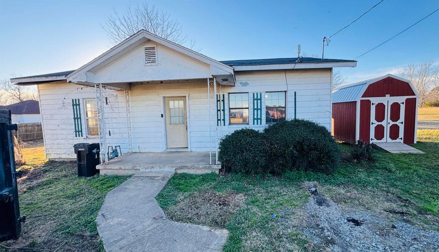 Being sold as is. Tons of potential. Large lot. Detached garage. Storage building stays.