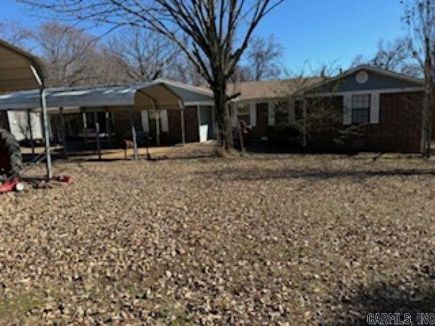 This large home sits in a comfy country neighborhood.  It offers 3 carports, large front and back yards, large trees and woods next door.  Once inside you will find a nicely sized bonus room, living room, dine in kitchen with island and breakfast nook.  Builtins, 3 bedrooms and 2 bathrooms round out the perfect home for any stage of home ownership. Hurry and look because this one won't last long.