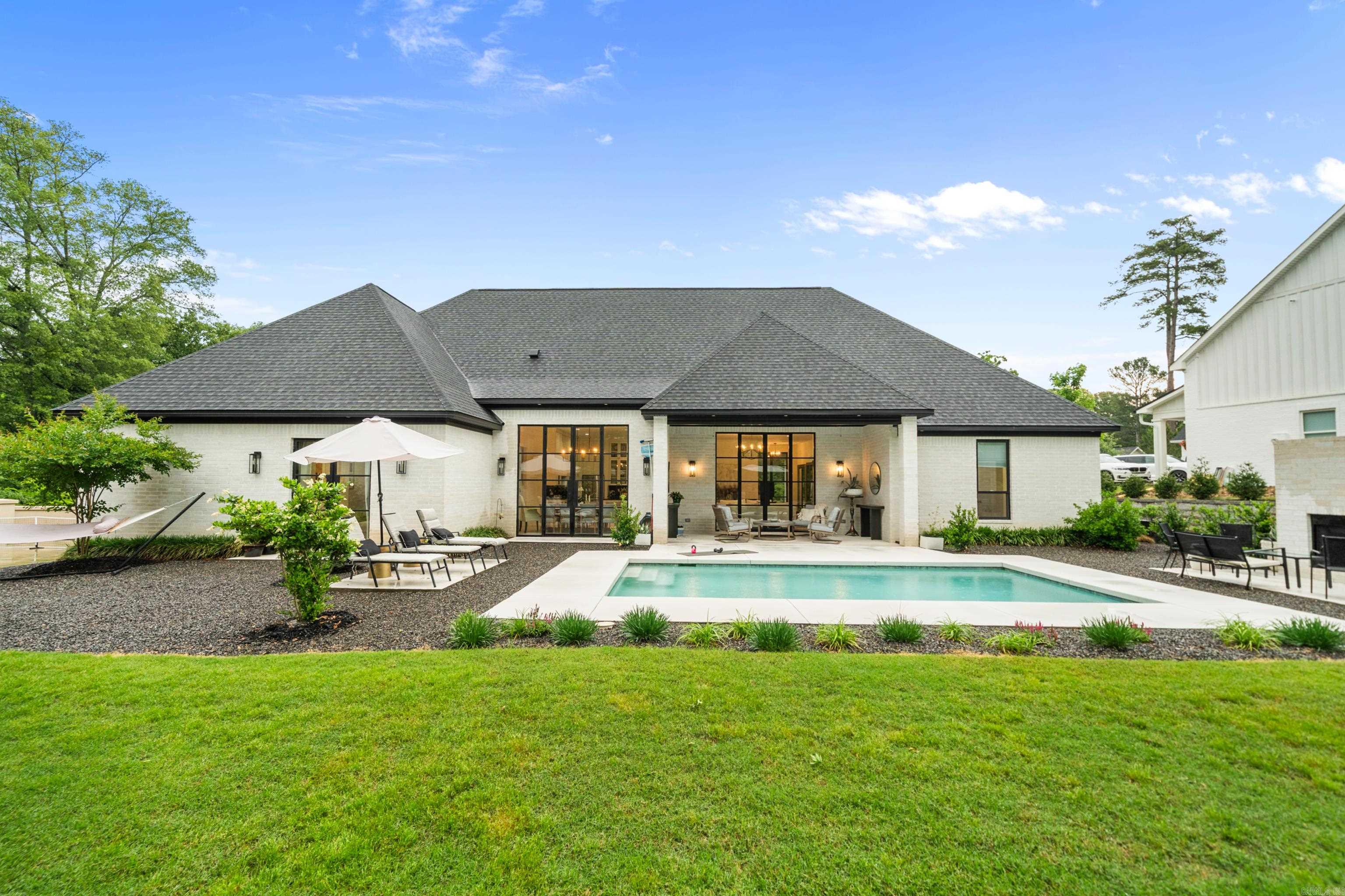 Luxury, Leisure & Lifestyle – All in One STUNNING Package! Tucked away at the end of a quiet cul-de-sac, this exquisite contemporary retreat offers a dream-worthy blend of privacy, style, and show-stopping outdoor amenities! Sitting on a flat, private lot, the lush custom landscaping sets the tone for the resort-style experience that awaits. Step into your backyard paradise—complete with in-ground pool, outdoor kitchen, outdoor fireplace, and covered porch perfect for entertaining. Enjoy your own PRIVATE PICKLEBALL COURT, large workshop, raised bed gardens- a backyard that truly HAS IT ALL. Inside, this single-level home boasts 3,274 sq ft of smartly designed living space with 4 bedrooms, 2.5 baths, and thoughtful extras like a dedicated office and home gym. The open-concept floor plan features soaring ceilings, walls of custom windows, and elegant finishes throughout. The heart of the home is the chef’s kitchen—fully outfitted with high-end stainless appliances, a massive island, and a huge walk-in pantry. The primary suite features a spa-like ensuite bathroom with oversized his and hers closets that connect to laundry area. Looking for unmatched luxury living - this is it!