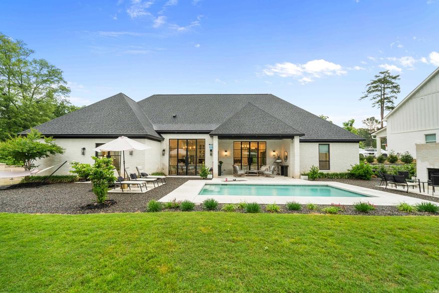 Luxury, Leisure & Lifestyle – All in One STUNNING Package! Tucked away at the end of a quiet cul-de-sac, this exquisite contemporary retreat offers a dream-worthy blend of privacy, style, and show-stopping outdoor amenities! Sitting on a flat, private lot, the lush custom landscaping sets the tone for the resort-style experience that awaits. Step into your backyard paradise—complete with in-ground pool, outdoor kitchen, outdoor fireplace, and covered porch perfect for entertaining.  Enjoy your own PRIVATE PICKLEBALL COURT, large workshop, raised bed gardens- a backyard that truly HAS IT ALL. Inside, this single-level home boasts 3,274 sq ft of smartly designed living space with 4 bedrooms, 2.5 baths, and thoughtful extras like a dedicated office and home gym. The open-concept floor plan features soaring ceilings, walls of custom windows, and elegant finishes throughout. The heart of the home is the chef’s kitchen—fully outfitted with high-end stainless appliances, a massive island, and a huge walk-in pantry. The primary suite features a spa-like ensuite bathroom with oversized his and hers closets that connect to laundry area. Looking for unmatched luxury living - this is it!