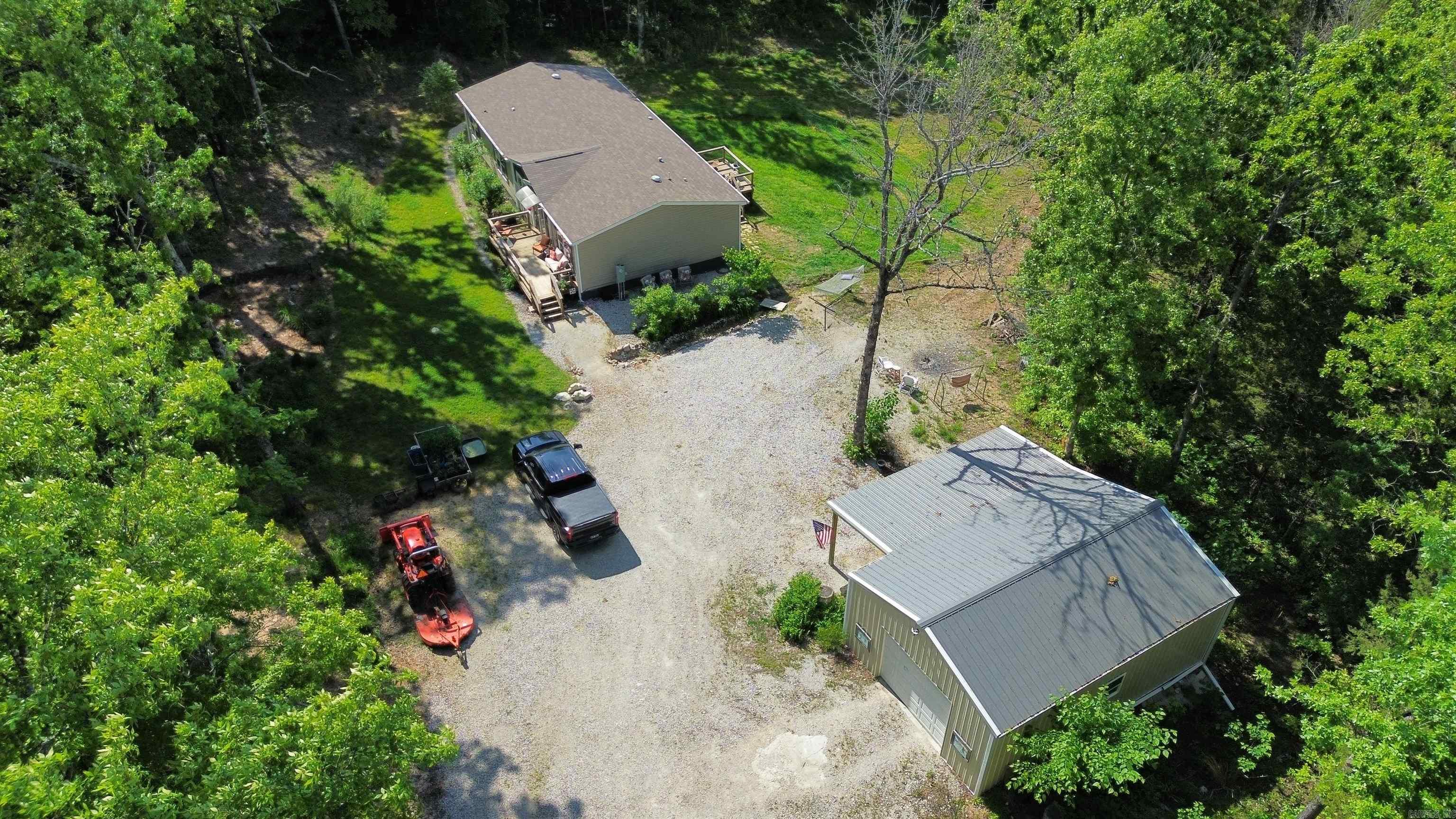 This secluded 3-bedroom, 2-bathroom manufactured home was built in 2021 and is situated on 10 beautiful acres in Oxford, Arkansas. The property offers a perfect blend of cleared and wooded land—ideal for enjoying nature, recreation, or small-scale homesteading. The home is solidly built with 6 inch insulated walls for excellent energy efficiency and has been well cared for. There is a spacious and functional layout that includes a den/family room, bonus room, and laundry room. The kitchen comes fully equipped with appliances, and the home also features central heat and air, public water, septic system, and a crawl space foundation. A termite contract is already in place, adding peace of mind for the next owner. What truly sets this property apart is the incredible workspace and storage potential. There’s a 24x25 detached garage with an electric door opener and insulated ceiling, a 20x30 workshop with two garage doors, and an additional 24x25x11 garage with lean-to—perfect for projects, hobbies, or equipment storage. Whether you need a place for tools, vehicles, or a home-based business, this setup is ready to go. Priced at $263,900—call today to schedule your private showing!