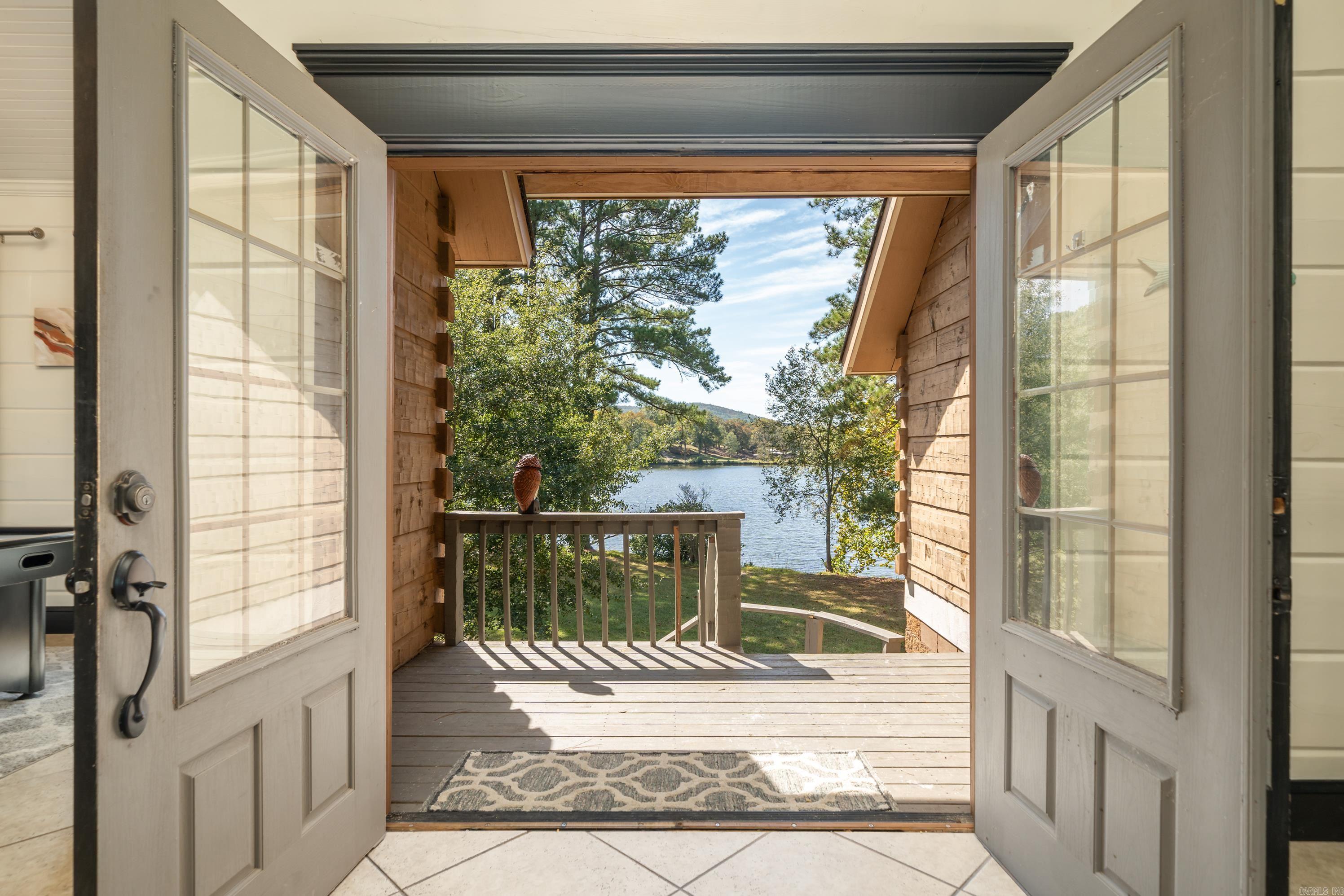 This exclusive private peninsula offers a rare opportunity to own a gated retreat in one of the most sought-after lakefront locations. Currently operating as a highly successful short-term rental, the property generates well over six figures annually. Two of the homes each feature three bedrooms, providing ample space and comfort. The smaller cabin has 1 bedroom and is perfect for a quick getaway! The Bus includes one bedroom and one bathroom, with an additional RV hookup available. A fourth shed-style structure is currently used for storage but has the potential to be converted into a tiny home. There is room on the property to develop another cabin or to add another stylish Bus! The property boasts exceptional water access and views with a two-slip covered boat dock with a swim deck, a separate swim dock, and a pier. Offering unmatched privacy and stunning lake views, this unique investment opportunity is perfect for those seeking a profitable rental or a private waterfront escape.
