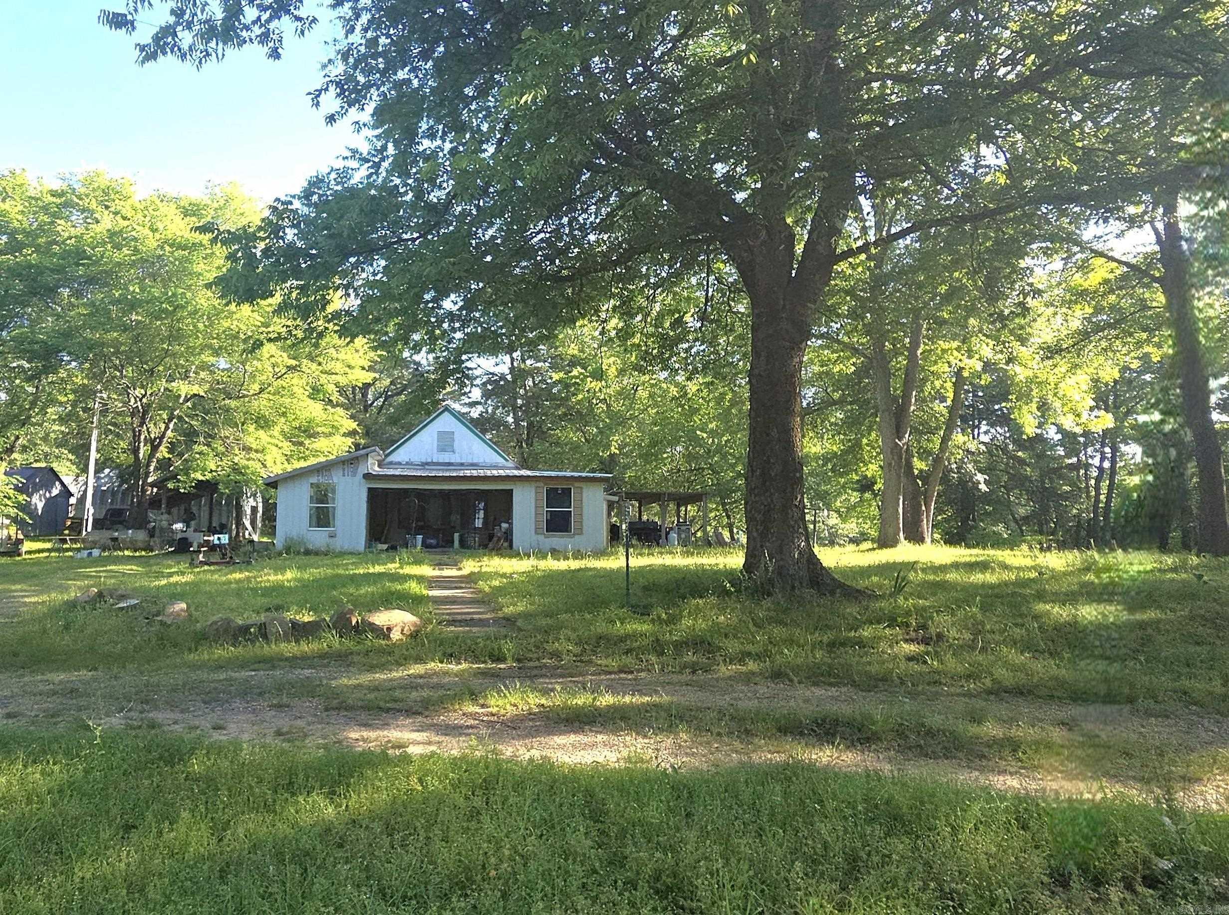 Motivated Seller! If you're dreaming of a simpler, more grounded lifestyle, this 2 acre homestead is your perfect escape. Featuring a fixer upper farmhouse with roots dating back to 1885 when the original home was built & then expanded over the years. Home will need electrical updated! Wake up to the peaceful sight of deer just outside your bedroom window, tend your garden in the morning shade as the sun is peeking through the trees. Enjoy the established muscadines come harvest season. 30x30 Shop (built in 2004) is wired for electric & plumbed for a bathroom. Shed with tack room and storage/parking space. 8” concrete slab currently set up for a chicken coop and dog pen. Could also suit a greenhouse, or utilize it to build your dream home! This property is ideal for anyone looking to embrace country living. Come walk the property, feel the breeze, and imagine the life you can build here.
