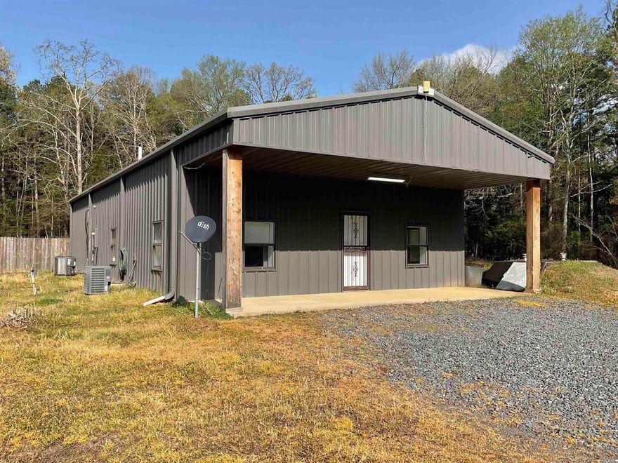 What a great home built like a barndominium with it's metal siding and roof.  Wonderful floorplan with the master to the rear and private with a great bath (deep soak tub, walk-in shower) & one of the biggest closets you will ever see. Great-room/dining/kitchen all open, great-room has built-ins & 3 ceiling fans.  The wide expansive windows give you great viewing of the property and the nice woods beside.  Watch the deer play!! The kitchen has more than ample countertops & cabinets, electric range with microwave vent-a-hood, breakfast bar and the neatest concrete countertops, home has 4" slab, Hurricane windows, steel doors, fenced back yard, storm cellar and two car carport.s, home is 2 zoned units, 2x12 ceiling joists, red iron structure & boat launching ramp minutes away.