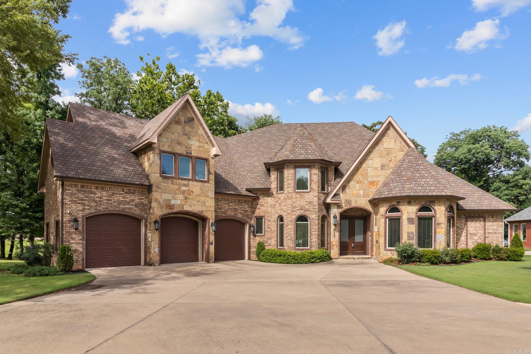 STUNNING LAKEFRONT PROPERTY WITH EAST VIEWS! Nestled on over 1/2 acre, this property offers a picturesque setting. The kitchen is a chef's delight, boasting a 6-burner gas range with double oven, an oversized built-in refrigerator, and a walk-in pantry. Work in style from the dedicated office, enjoying a tranquil view of the lake. The spacious living room features a coffered ceiling, built-ins, and a cozy gas fireplace. Retreat to the primary suite, where you'll wake up to breathtaking lake views, vaulted ceilings, a walk-in shower, double vanity, and a generous closet. Throughout the home, you'll find gorgeous moldings and hardwoods, adding a touch of elegance. Each bedroom comes with its own en-suite bathroom for added convenience. Start your mornings in the separate breakfast area with a bay window, or host formal dinners in the dining room. Two bedrooms on the main level offer flexibility and convenience. The bonus room with a wet bar is perfect for entertaining, and two balconies provide additional space to relax and enjoy the lake view. Unwind on the covered back porch, taking in the serene surroundings. This home is a true oasis!