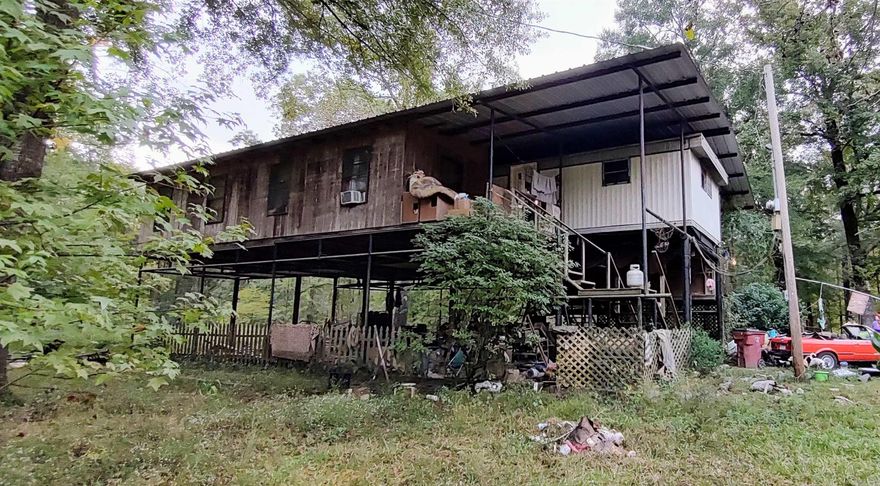 If you are looking for a place to live around water or are looking for a getaway, 4668 Calhoun 245 can give you that with Champagnolle creek! You are still close to Eldorado & Hampton. This property has 2.3 acres. The mobile home was added onto so it gives you more room to spread out. The sunroom could be turned into a den/family room or made into a bedroom. The possibilities are endless – you can make this home into your perfect getaway!