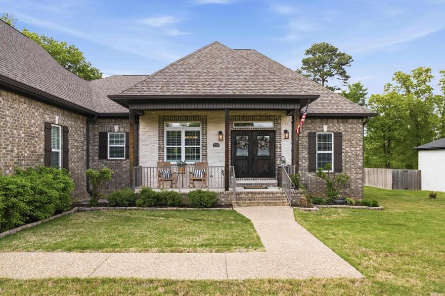 Experience luxury living just moments from Lake Hamilton in this stunning 4-bedroom, 2.5-bath home with deeded lake access. Inside, rich hardwood floors, recessed lighting, vaulted ceilings, and an open floor plan create an inviting, upscale feel. The kitchen features custom cabinetry, granite countertops, stainless steel appliances, and seamless flow for entertaining, while the electric fireplace adds warmth and sophisticated charm. The spacious primary suite offers dual closets, double vanities, and a relaxing jetted tub. Step outside to an expansive backyard deck, covered patio, and peaceful views where deer are often seen. A 10x16 shed with electricity adds extra versatility. Blending upscale finishes, outdoor charm, and boat launch access to Lake Hamilton, this exceptional property presents a rare opportunity to enjoy the best of lake living.