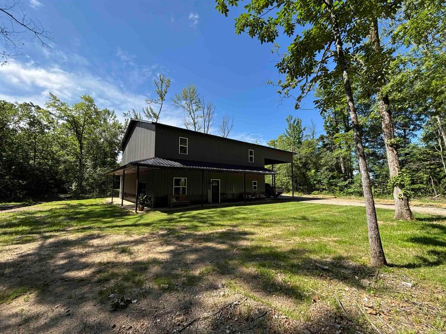 Barndominium style charm meets modern comfort in this spacious 4-bedroom, 3-bath, two-story home in the Jessieville School District! With approx. 2,800 sq ft, this unique property features a game room, office, mudroom, and an open living area ideal for entertaining. The kitchen and dining room showcase stunning tongue-and-groove wood ceilings, adding warmth and character. Upstairs, enjoy a cozy loft and balcony perfect for relaxing with a view. The master bed/bath offers a luxurious whirlpool tub for unwinding. The home sits on 13.09 scenic acres with a beautiful creek that flows into a stocked pond perfect for fishing or simply enjoying nature. A two-car carport and central heating & cooling add convenience and comfort. This one-of-a-kind property combines rustic style with modern amenities don’t miss your chance to own this beautiful property!