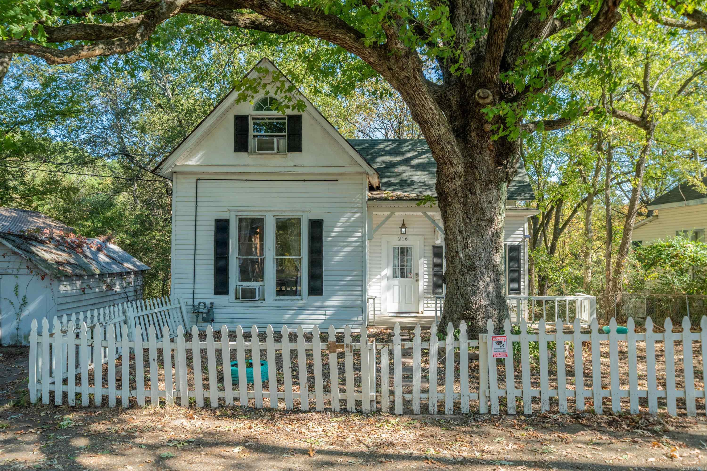 Donāt miss this rare opportunity to own a charming 3-story home just minutes from Downtown Hot Springs, full of character & potential! Built in 1923, this 6-bedroom, 2-bathroom residence offers 1,700 sq ft of living space & is located in the Hot Springs School District. Step inside to discover architectural details like high ceilings, built-ins, & a beautiful staircase. The home features generous living areas with a layout that offers great potential for multi-generational living or rental income. The lower level has its own private entrance & includes 2 bedrooms, a full bathroom, & a living room-making it ideal for a separate apartment or guest quarters. The finished basement has interior access to the crawlspace offering extra storage. Outside, enjoy a large backyard, complete with a deck & partially fenced-in area for added privacy. With 3 off-street parking pads, thereās plenty of room for you & your guests. This home is being sold AS-IS, offering a great chance for investors or homeowners to add their personal touch & build equity. Whether you're looking for a family home or an income-generating property, this one has the bones & location to make it truly special.