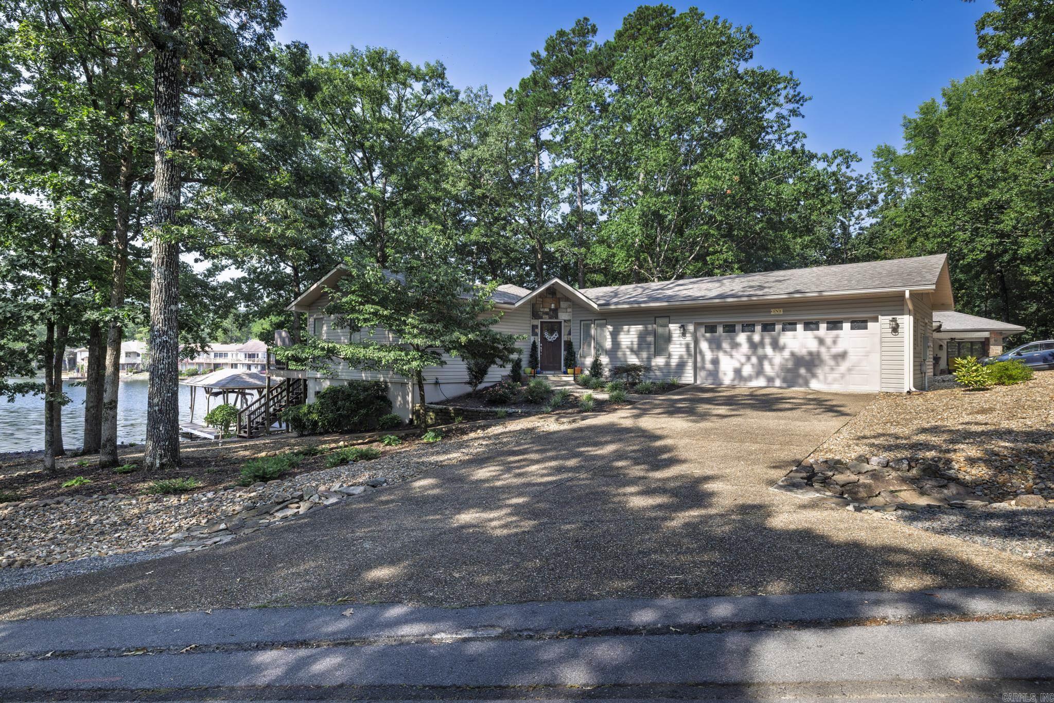 169 ft water front home on LAKE DESOTO. The gentle sloping maintenance free lot has drip irrigation for the plants, newer covered boat dock with lift -2021. On the main level check out the updated kitchen with all appliances coveying. This includes 2 refrigerators, washer and dryer, stove, mini ref, and micro. Primary Bedroom with remodeled bathroom (2023) Lower Level remodel (2023) Roof 2020, water heater 2023